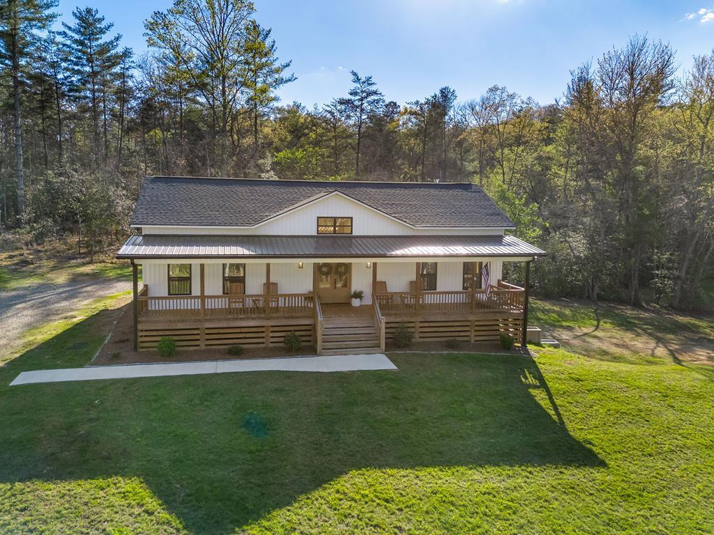 Beautifully crafted custom farmhouse-style home in the heart of Blairsville, GA, offering the perfect blend of modern comfort and mountain charm. Built just a few years ago, this 3BR/2BA home features a thoughtfully designed split floor plan with the primary suite privately situated on one side and two additional bedrooms on the other.  The open-concept living area is anchored by a stunning oversized kitchen island perfect for entertaining along with a walk-in pantry that truly checks every box. The primary suite offers a spacious layout, tile shower, and an impressive walk-in closet.  Enjoy peaceful surroundings just across the road from Poteete Creek and minutes to Lake Nottely. The full unfinished basement provides endless potential for expansion, whether you're envisioning additional living space, a game room, or guest quarters.  An additional 1-acre lot is available for separate purchase, offering the rare opportunity to own over 2 unrestricted acres in this desirable location.  If you've been searching for a newer home in Union County with character, space, and room to grow this one is a must-see!