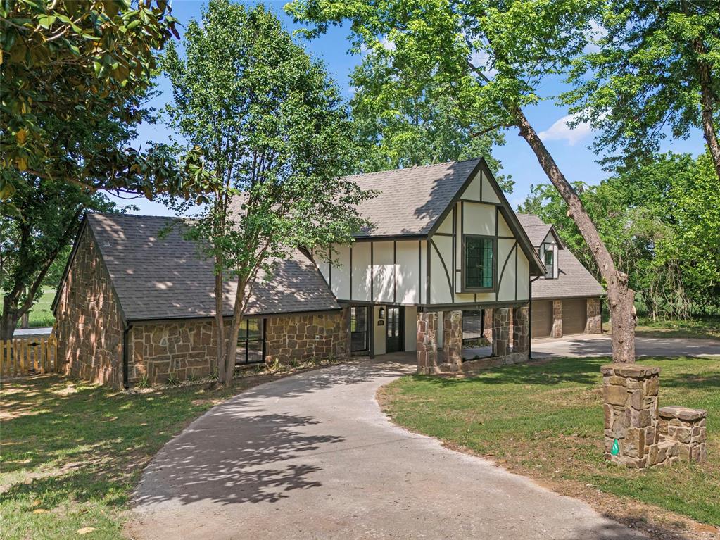 Minutes from I-35, shopping, dining, and the OU campus + NO HOA. Peaceful country setting. Washington School District. This charming Tudor-style home has been beautifully remodeled and offers a rare balance of privacy and convenience. A grand entry with an exposed staircase and chandelier opens to a spacious living room with vaulted ceilings and a full-length stone fireplace, creating a warm and impressive first impression. The home has been thoughtfully updated while still preserving original character.The layout is highly functional, with each bedroom featuring its own full bathroom. The fourth bedroom includes a private entrance and full bath—ideal for a guest suite, second living area, home office, or study.Outside, enjoy peaceful farmland views from the backyard, patio, and balcony. The large backyard provides space for outdoor living, recreation, or future additions, including room for a pool or workshop on the existing concrete pad. An extra-deep, fully insulated garage adds even more flexibility.USDA financing is available for qualifying buyers!