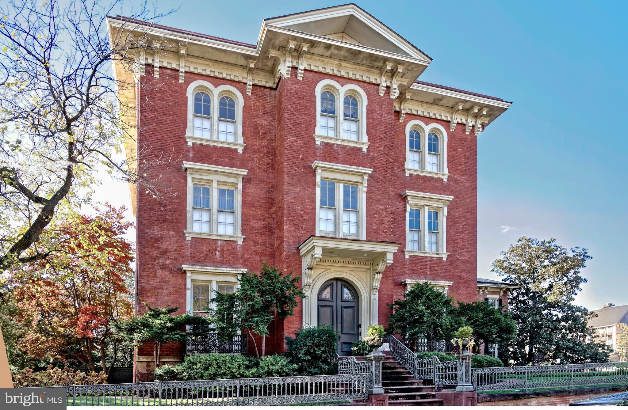 Now available for the first time in 40 years is an iconic estate property, the largest, most distinguished home in coveted Old Town, Alexandria! Spanning 14,000+ square feet and set on a generous half-acre lot, this expansive historic house presents a one-of-a-kind opportunity for the discerning buyer who appreciates incomparable elegance, prewar charm, and modern amenities in a premier location. Built in 1854, 510 Wolfe Street is brimming with architectural character and original details. From the stately brick façade and original ornate iron fencing to the gracious 3-story interiors, grandeur is embodied at every turn. The magnificent residence further entices offering all the comforts one could desire, with its own 4-car garage and ample driveway parking, lush private yard and sunken garden with irrigation, lovely porch with a wisteria-covered pergola, and large paver-stone patio with fans and lighting for the ultimate outdoor enjoyment. Adorning the spectacular main home are exquisite elements throughout, among them soaring ceilings up to 12’6”, original plaster ceiling rosettes/medallions, oversized windows inviting in beautiful natural light, 13 fireplaces (12 with original mantels), antique chandeliers, original heart pine floors, solid 6’ Virginia heart pine doors, rare 1950’s English dolphin motif stained glass accents, original crown molding/base trim, and an original circular staircase with walnut handrails ascending to upper floors. The stunning main level affords an ideal backdrop for entertaining. Off the gracious entry foyer sits an enormous double-parlor great room with dual fireplaces to gather around, each with marble mantles and gilded gold leaf period-matching mirrors above. Serve gourmet meals in the regal formal dining room with a butler’s pantry, connected to an original eat-in country kitchen that can be updated to suit the contemporary chef. This level also features a handsome study for lounging with coffee or cocktails; a fabulous sky-lit conservatory-sunroom with original hand-molded brick floor, original sandstone window sills, and glass doors to the rear yard; a full laundry room; and a guest powder room. Occupying the two upper floors, each marked by airy 11’6” ceilings and open landings furnished as sitting areas, are 6 bedrooms, plus a secluded in-law or guest suite with a living room, 7th bedroom, kitchenette and full bath. The primary suite is a tranquil retreat complete with a dressing room and en-suite bath, and access to a library with built-in bookshelves in the hall. Other highlights include a 1,732 sq ft unfinished top level walk-up attic with extensive storage space, stairs to a widow’s walk for savoring extraordinary Potomac River and city views, and a domed beehive brick ice house/ice cellar adding a unique touch. What’s more, there are 2 spacious 1,194 sq ft apartments privately located on the home’s ground level. Each comes with 2 bedrooms, 1.5 baths, a full kitchen, a washer & dryer, and dedicated HVAC unit – perfect for rental income, guest quarters, or conversion to exercise or office space for your personal use.  Own a special piece of Alexandria history and enjoy an unparalleled standard of living, at a prime address close to the waterfront, shops, restaurants and transportation.