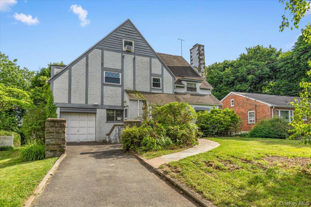 Bring your vision and creativity to this spacious Tudor-style home located in the desirable Wykagyl area of New Rochelle on a quiet dead end street. Offering approximately 2,465 square feet of living space, this home features 5 bedrooms, 3.5 baths, a generous living room, formal dining room, family room, and kitchen. Rich in character and architectural charm, this property presents an exceptional opportunity for buyers looking to renovate and customize a home to their own taste and style. With solid space, a desirable layout,  beautiful private level backyard and a prime location close to schools, parks, shopping, house of worship and transportation, the possibilities are endless. A true diamond in the rough awaiting its next chapter. Property being sold as-is.