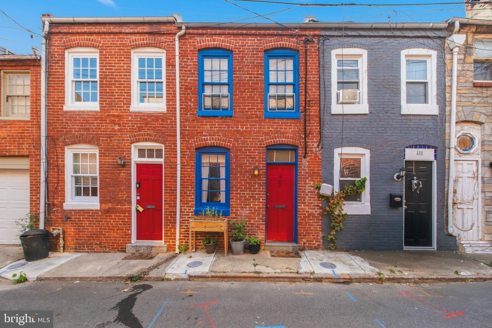 Located in the heart of Historic Fells Point, just steps from Harbor East, Little Italy, and Baltimore's vibrant waterfront, this charming 1-bedroom, 1-bath brick rowhome perfectly blends historic character with modern comfort. From the classic red brick façade accented by bright blue shutters and the iconic red front door, this home embodies everything people love about Baltimore.Inside, you'll find a warm and inviting living space featuring original hardwood floors, exposed brick, wood beams, neutral paint tones, and abundant natural light. An updated kitchen, with an adjoining dining area makes the most of every square foot, proving that great design comes in all sizes. Washer and dryer are conveniently located on the main level as well. Just beyond the kitchen awaits one of the home's most enchanting features—a private, ivy-covered English garden. Surrounded by mature climbing vines and highlighted by a charming brick patio, this peaceful outdoor retreat is perfect for morning coffee, grilling with friends, or simply unwinding after a day in the city.Upstairs, the spacious bedroom offers soaring ceilings,  the room is filled with natural light, generous closet space, and a versatile nook ideal for a home office or cozy reading corner. The beautifully updated bathroom (2023) features modern fixtures, a stylish vanity with storage, and a spa-inspired shower with a rain showerhead.Thoughtful updates throughout the home complement its timeless character while providing the conveniences of modern living. With easy access to public transportation, restaurants, boutique shopping, waterfront parks, and neighborhood favorites, this home offers an unbeatable opportunity to enjoy the very best of city living.This storybook rowhome is full of personality, charm, and character—a truly special place you'll be proud to call home.