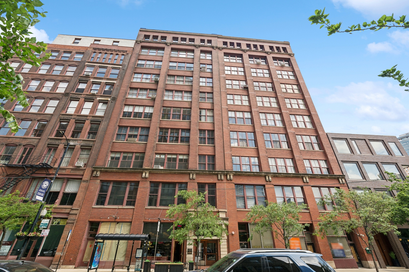 Historic charm meets modern comfort! Presenting a special and unique opportunity to own in the historical landmark building, The Donohue, located in the heart of Printers Row. Originally built in 1883, the Donahue building was the first factory building in Chicago to be converted to residential lofts in 1979. Inside the building, you will experience the wonder and charm of the original elevator operated via a pulley system to get to the 9th floor. Stepping into this true concrete loft, you will be greeted by a sprawling 40' wide open-concept floor plan with soaring ceilings, fireplace seating area, and built-in bookcases, a nod to the printer press factory this once was. As you explore, you will find 3 bedrooms and 2 baths with no expense spared in the many upgrades throughout. The kitchen has a timeless and elegant feel featuring high-end appliances, a waterfall edge island, and beautiful two-toned cabinetry, which leads to the very rare and expansive outdoor space. Your private outdoor oasis is right off the kitchen, perfect for entertaining while looking at views of the Willis Tower, John Hancock Building, and more. The primary bedroom is the epitome of luxury and relaxation, complete with an impressive walk-in closet. The equally impressive primary bathroom boasts a huge custom shower, marble flooring, and double sinks, flooded with natural light. Located in a special area in the heart of downtown Chicago, with the weekend farmers market in the park just across the street. Steps from many restaurants, cafes, bookstores, and more right out our front door. A nearly perfect walk score of 99! Prime garage heated parking available at 801 S Plymouth for an additional price.