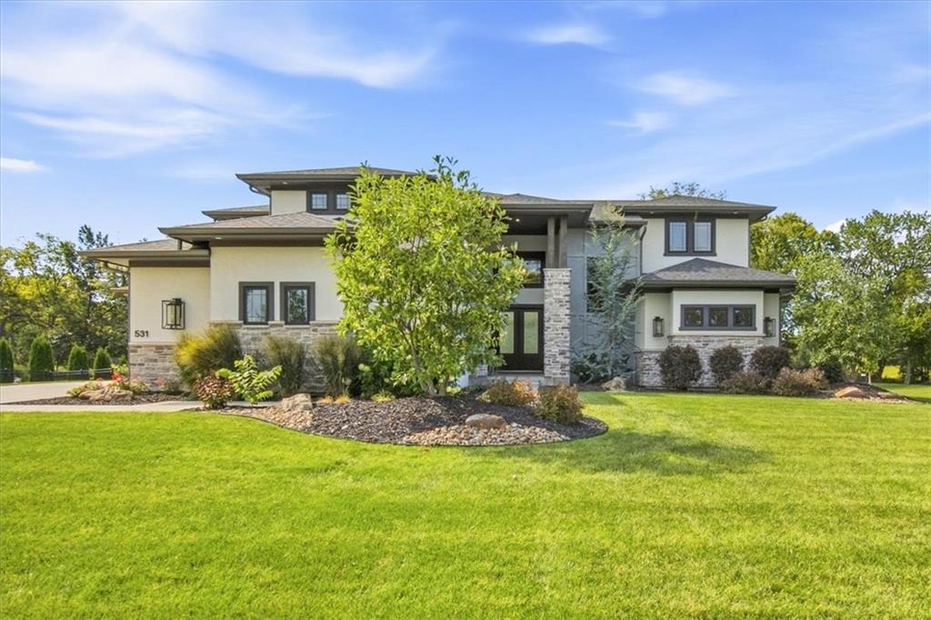 Better than new and absolutely impeccable, this extraordinary Lake Winnebago home delivers the ultimate combination of luxury, lifestyle, and lake access. Located on Tier 2 with its own dedicated boat slip, 531 South Shore Drive offers exceptional design, beautiful finishes, and a setting that backs to green space for added privacy.This stunning 1.5-story home is thoughtfully designed for both everyday living and entertaining, with 10-foot ceilings, 8-foot doors, and a floor plan that feels open, elegant, and effortless. The show-stopping kitchen features a dramatic 10-foot island, beautiful cabinetry, and a separate prep kitchen, while the adjoining mudroom with built-in lockers and pocket office add incredible function without sacrificing style.The main-level primary suite is a true retreat with a gorgeous spa-like bath, heated floors, and a spacious walk-in closet. Upstairs, every bedroom features its own ensuite bath, plus a kids' loft and second laundry area for added convenience.The daylight lower level offers even more exceptional living space, including a large workout room and tremendous storage, with additional excavated space beneath the garage. The four-car garage is equally impressive with coated floors and plenty of room for vehicles, lake toys, and more.Outside, the home continues to impress with a beautiful pool, and an outdoor gas fireplace—creating an incredible space to relax, entertain, and enjoy the Lake Winnebago lifestyle.From the thoughtful floor plan and impeccable finishes to the pool, four-car garage, dedicated boat slip, and private green-space setting, every detail has been carefully considered. This is a truly exceptional home and a rare opportunity to enjoy luxury living at Lake Winnebago. This is a second tier home, which gives you access to your own dock.