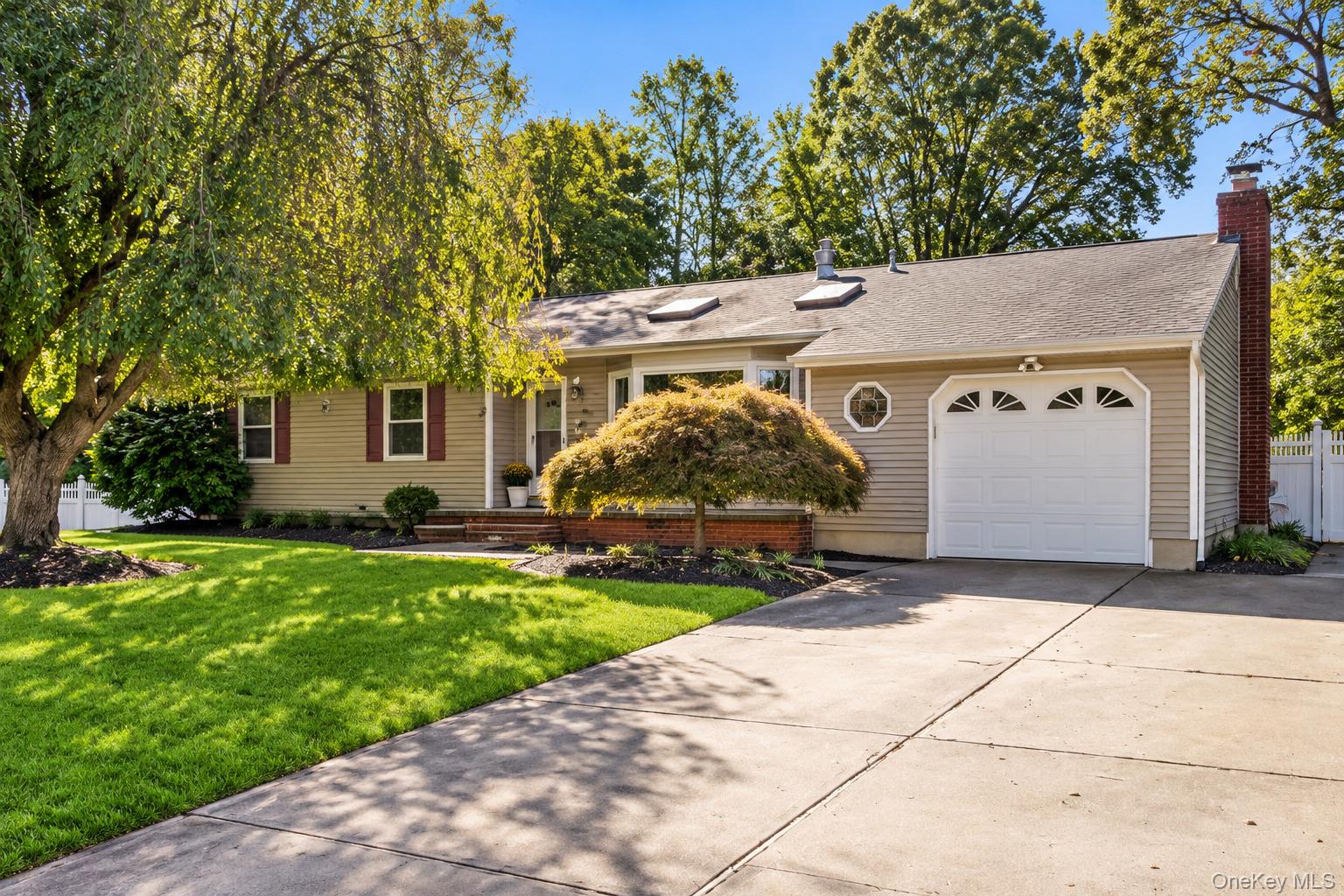 Welcome to this charming 3-bedroom, 2-bath ranch in Selden, NY, located within the Middle Country School District! Offering comfortable one-level living, this inviting home features a living room with a vaulted ceiling, beautiful bay window, and fireplace, creating a warm and welcoming atmosphere. The eat-in kitchen features cathedral ceilings, stainless steel appliances, granite countertops, and sliding glass doors leading directly to a spacious deck, perfect for outdoor dining, entertaining, or enjoying your morning coffee. The large, fully fenced backyard offers plenty of room for recreation, gardening, and summer gatherings. The full finished basement provides valuable additional living space, ideal for a family room, home office, fitness area, or recreation room. With its functional ranch-style layout, large attractive kitchen area, finished basement, and wonderful indoor and outdoor living spaces, this home offers comfort, charm, and versatility. Conveniently located near shopping, dining, parks, and major roadways, this Selden ranch is ready to welcome you home!