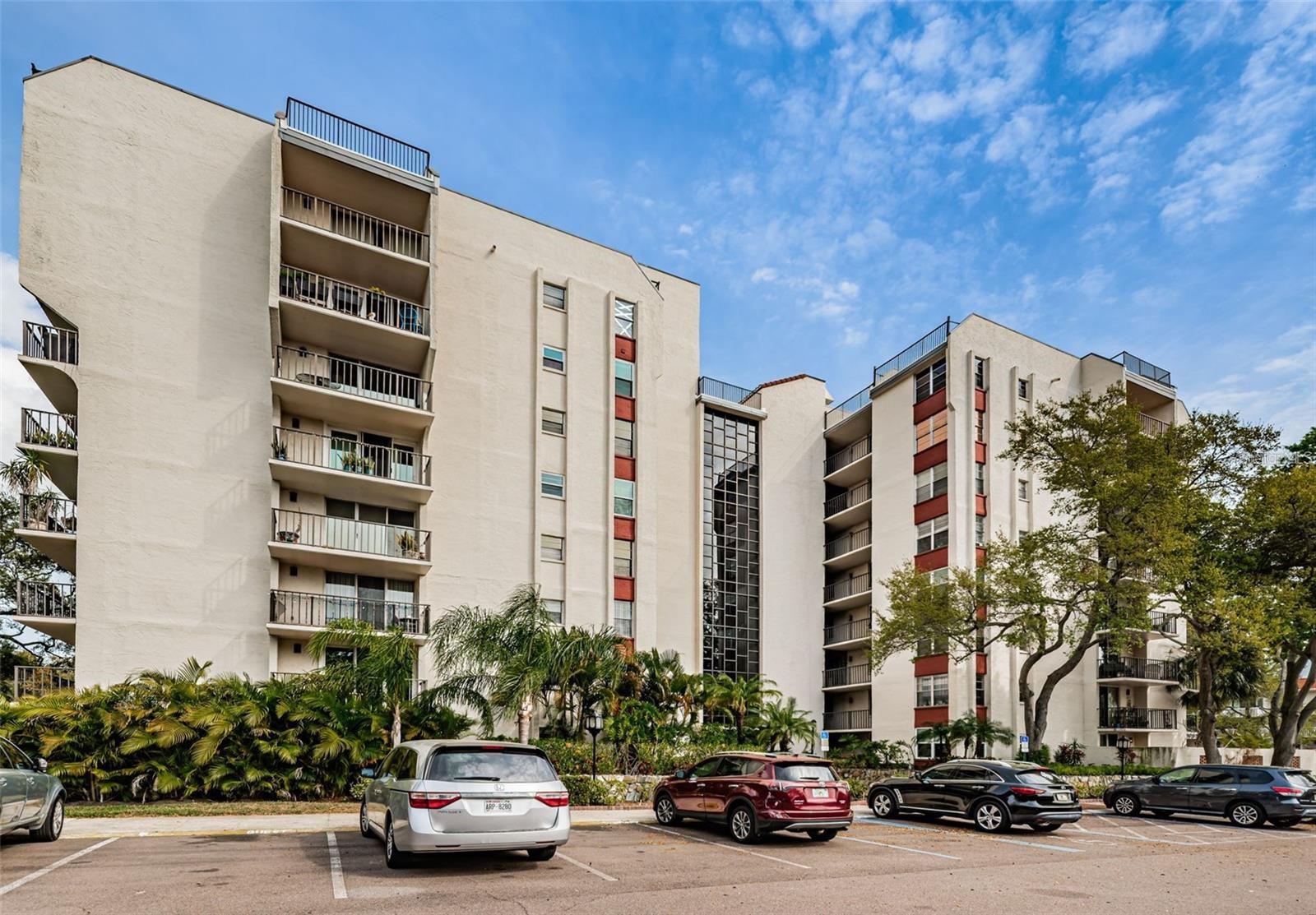 MOVE RIGHT IN to this spacious FIRST-FLOOR CORNER UNIT in desirable Seville Condos, offering an impressive 1,450 SQ. FT. OF INTERIOR LIVING SPACE, a SPLIT-BEDROOM FLOOR PLAN, abundant storage, and a private WRAP-AROUND PAVER PATIO surrounded by mature tropical landscaping. With 2 bedrooms, 2 bathrooms, generously sized rooms, and exceptional closet and storage space throughout, this condo offers the SPACE and functionality that can be difficult to find in condo living. The highly desirable BOTTOM-FLOOR, CORNER LOCATION provides added privacy, ABUNDANT NATURAL LIGHT, and convenient ground-level access with no stairs required. Step right outside your unit to the nearby DOG WALK AREA or your ASSIGNED COVERED PARKING SPACE. The expansive wrap-around paver patio creates additional outdoor living space and a peaceful setting surrounded by scenic mature trees.Inside, the SPLIT FLOOR PLAN provides privacy between the spacious bedrooms, while LUXURY VINYL PLANK FLOORING flows throughout the home. The UPDATED KITCHEN features QUARTZ COUNTERTOPS, a decorative tile backsplash, STAINLESS STEEL APPLIANCES, and generous cabinetry and storage. Both bathrooms have also been tastefully updated.One of the home's most UNIQUE AND HARD-TO-FIND FEATURES is the WASHER AND DRYER INSIDE THE UNIT. Per the seller, the in-unit washer and dryer has been GRANDFATHERED IN BY THE ASSOCIATION, providing a level of convenience not commonly available within the community.Additional improvements include a NEWER HVAC SYSTEM installed in November 2023 and a 2023 ROOF, with the related roof assessment paid. Per the seller, there are NO CURRENT PENDING ASSESSMENTS. The building has also completed its required structural integrity/milestone inspections, according to information provided by the seller/association.Enjoy MAINTENANCE-FREE FLORIDA LIVING with community amenities that include a SWIMMING POOL, FITNESS CENTER, CLUBHOUSE, and beautifully maintained RESORT-LIKE LANDSCAPING throughout the community. Another important advantage is the property's convenient location in FLOOD ZONE X. Seville's peaceful setting is surrounded by mature trees and lush landscaping, with scenic TAMPA BAY WATER VIEWS nearby. The community is ideally located in CLEARWATER, providing convenient access to shopping, dining, BayCare Ballpark, Ruth Eckerd Hall, major roadways, and everything the Tampa Bay area has to offer. CLEARWATER BEACH is approximately 15 minutes away, with convenient access to both Tampa International Airport and St. Pete-Clearwater International Airport. With 1,450 SQ. FT., a SPLIT FLOOR PLAN, exceptional storage, FIRST-FLOOR CORNER LOCATION, abundant natural light, WRAP-AROUND PAVER PATIO, IN-UNIT WASHER AND DRYER, covered parking, updated finishes, and a MOVE-IN-READY interior, this condo offers a combination of SIZE, LOCATION, STORAGE, and CONVENIENCE that is hard to find. Schedule your private showing today!