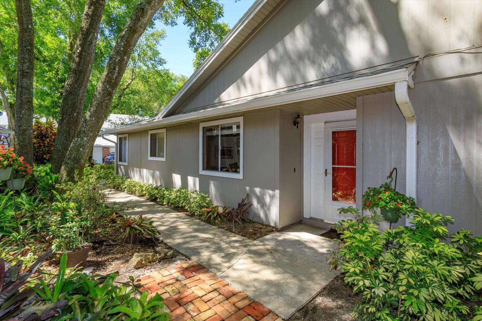 One or more photo(s) has been virtually staged. Lakeside Luxury Living in Altamonte Springs – Updated FIRST FLOOR - END UNIT - 2BR/2BA Condo with Resort-Style Amenities. 

Welcome to your serene retreat in the heart of Altamonte Springs!  Located in a private, GATED LAKEFRONT COMMUNITY with tree lined streets, this beautifully updated 2-BEDROOM, 2-BATHROOM condo offers modern elegance, comfort, and an unbeatable lifestyle.  Step inside to discover an open, light-filled floor plan with soaring ceilings and skylights.  The completely renovated kitchen features brand-new cabinetry, luxurious quartz countertops, and stainless steel appliances—perfect for both everyday living and entertaining.  Throughout the home, LUXURY WOOD LAMINATE FLOORING is paired with LARGE MODERN TILE in the UPDATED BATHROOMS for a cohesive, contemporary look.  Enjoy added flexibility with a spacious BONUS ROOM—ideal for a home office, reading nook, creative space, or 3rd bedroom. Unwind year-round in the FULLY INSULATED FLORIDA ROOM overlooking a lush, private green space.  The brick patio is your own peaceful oasis, surrounded by mature trees and tropical landscaping.  The spacious primary suite offers a spa-like ensuite bath with a dual-sink vanity, oversized walk-in shower, and a large walk-in closet.  The split-bedroom layout enhances privacy, and the home is tastefully finished in calming, neutral tones with ceiling fans throughout and ample storage.  For the hobbyist or those needing extra storage, the ATTACHED GARAGE features extensive shelving to keep everything organized along with your very own dedicated WORKSHOP space.
 Major upgrades include:
NEW HVAC (2024);
UPDATED PLUMBING and ELECTRICAL;
NEW ROOF;  EXTERIOR PAINT & GUTTERS.

Resort-Style AMENITIES Include:
• 2 sparkling SWIMMING POOLS
• CLUBHOUSE with kitchen/bar, GAME ROOMS - BILLIARDS, PING PONG, GAME TABLES, Special Events & regular weekly Activities to participate at your leisure
• FITNESS CENTER and Pickleball, Tennis and Basketball COURTS for day or night play
• BBQ area and expansive lawn for gatherings & enjoying the 4th of July fireworks of Cranes Roost Park
• Private COVERED DOCK, BOAT PARKING, WATER SPORT RACK STORAGE and access to Lake Orienta
• PET-FRIENDLY (no breed or weight restrictions)
• HOA includes HIGH-SPEED INTERNET AND PREMIUM CABLE TV.  

Prime Central Florida Location:
Minutes from shopping, dining, hospitals, airports, and public transit.  Just 15 minutes to Downtown Orlando and 45 minutes to the beaches!  

Don’t miss your chance to own this move-in-ready gem in a vibrant, amenity-rich community. Schedule your private showing today and experience lakeside living at its best!