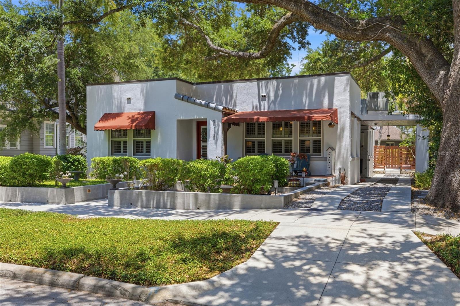 Perfectly positioned in the heart of Historic Hyde Park this extraordinary Spanish Revival residence offers one of South Tampa's most coveted lifestyles. Whether you're a power couple, a small family, or seeking the ideal retreat for your next chapter, this rare single-level estate provides a peaceful sanctuary while placing you at the center of it all. Here, quality takes precedence over quantity. A refreshing departure from the typical Hyde Park bungalow, this home is one of the area's rare examples of Spanish Revival architecture & the peace of mind of masonry construction. A long driveway leads to the porte-cochère to a covered side entrance, while garden-lined stem walls frame the approach to the inviting front porch. Anchoring the front yard, a majestic live oak serves as a reminder of Tampa's rich heritage. Recently painted SW "White Star," the exterior is complemented by soft gray trim and elegant copper-accents. Inside, hardwood floors and plantation shutters create a timeless backdrop throughout. The inviting family room centers around a wood-burning fireplace, while the spacious formal living and dining room offers exceptional versatility. Glass French doors open to the recently updated kitchen, where charcoal quartz countertops, soft gray shaker cabinetry, black hardware, and an ornate tile backsplash create a refined yet functional space. Stainless steel appliances, including a gas range, complete the ensemble. Just beyond, a charming alcove currently serves as an office but could easily become a breakfast nook. The bedroom wing offers privacy and character, highlighted by a delightful hall bath featuring a clawfoot tub and classic checkered tile floors. Through an arched opening, two generously sized bedrooms await, including a spacious primary suite complete with a custom walk-in closet and beautifully updated bath featuring marble finishes. Then comes the home's unforgettable centerpiece. Step outside and discover a truly resort-worthy oasis. Beneath the pergola-style covered patio with tongue-and-groove pine ceiling, you'll find the perfect setting for alfresco dining and relaxed evenings. The expansive swimming pool—large enough for morning laps—creates a tranquil backdrop surrounded by tropical landscaping, mature palms, and exotic plantings. Beyond the pool lies a hidden treasure—a remarkable 700-square-foot casita designed with the same Spanish Revival spirit. Enhanced with Saltillo tile floors, this private retreat offers its own pergola, family room, dining area, kitchen, bedroom, bathroom, and walk-in closet, making it ideal for multigenerational living, long-term guests, or a private home office. The entire backyard is enclosed by contemporary horizontal fencing. Perhaps most impressive is the lifestyle this address affords. Anderson Park—with playgrounds, basketball courts, and year-round events—is just steps away. Hyde Park Village, with its collection of Tampa's finest restaurants, boutiques, cafés, bars, Sunday markets, festivals, and CineBistro, is moments from your doorstep. And just five blocks away lies Bayshore Boulevard, home to the nation's longest continuous waterfront sidewalk known for walking, running, and cycling. Rarely does a home combine architectural significance, resort-inspired outdoor living, a private guest residence, and one of South Tampa's most walkable locations. Experience one of Hyde Park's hidden gems while the opportunity still exists.