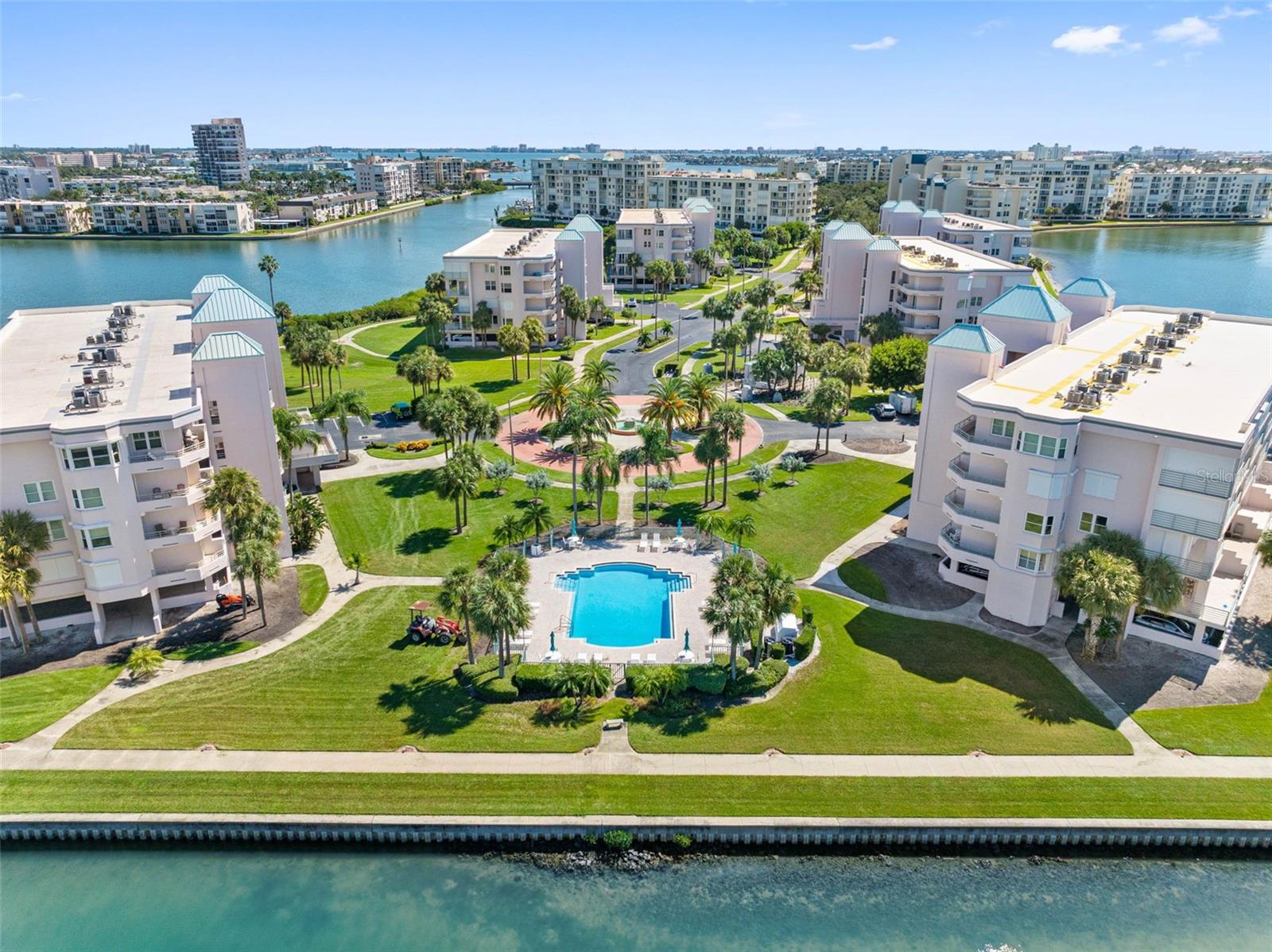 A fresh opportunity for buyers to enjoy the best of waterfront living at 8021 Sailboat Key, Apt. 304, located in HarbourSide's exclusive Coral Pointe.  Furniture, most of which was purchased recently, is included with the sale.  This inviting third-floor residence features two bedrooms, two baths, and a den/office with 1,265 square feet of thoughtfully designed living space (larger than many 2 BR/2 BA units).  Beautiful water views and a comfortable split-bedroom layout make it ideal for everyday living or a seasonal retreat.  Remodeled in 2024, the attractive wood-look Luxury Vinyl Plank flooring flows seamlessly throughout this condo that has an abundance of natural light.   The kitchen features shaker cabinets, quartz countertops, pretty teal glass backsplash and stainless-steel appliances. Brand new hurricane shutters with an unobstructed wide-open view were added in 2025.  Sliding glass doors open to a spacious waterfront balcony—an ideal setting for morning coffee or relaxing at the end of the day. The primary suite includes a generous walk-in closet and an en-suite bath with a step-in shower. A separate guest bedroom and bath provide privacy for family and visitors, while the den provides flexible space for an office, additional sitting or sleeping area.  In-unit laundry and assigned under-building parking #123 add to everyday convenience. Updates include a new A/C in 2021 and a water heater in 2024.  Two storage units, one on the balcony and another near the elevator, provide additional storage space. Harbourside offers a waterfront lifestyle with a gatehouse staffed around the clock.  Amenities include multiple swimming pools, tennis and pickleball courts, a fitness center, and a clubhouse. A scenic 1.5-mile waterfront walking path winds along the community’s shoreline, while a private marina and fishing pier enhance its coastal appeal.  Gulf beaches, local restaurants, and shopping are nearby, with vibrant downtown St. Petersburg’s museums, theaters, dining, and waterfront attractions just a short drive away. Discover the views, comfort, and convenience of Coral Pointe at Harbourside. Schedule your private showing today.