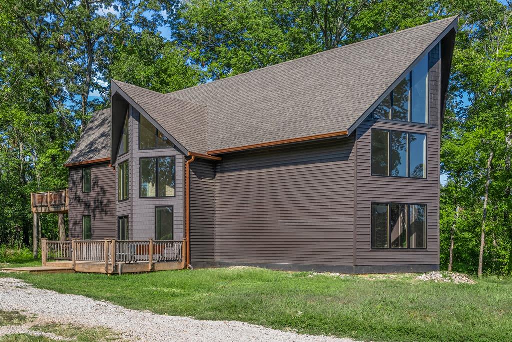 Rare and unique property on 11.5 beautiful country acres just minutes from town, featuring two homes! The main house, custom-built in 2023, offers 2800 sq ft of modern split-level living with soaring 30-ft cathedral ceilings, expansive open-concept design, and abundant natural light through Pella casement windows. Includes 3 beds, 2 baths (potential 4th bedroom), solid poplar doors/trim, Bespoke Samsung glass appliances, farmhouse sink, spa-like primary suite with huge walk-in closet and double walk-in tiled shower, plus an upper balcony. Efficiently climate-controlled with 2 three-ton and 2 four-ton mini-split units. The second home, fully remodeled in 2022, is 1650 sq ft with 2 beds, 1 bath, Hardie plank siding, new appliances, fixtures, bathroom, and flooring. Outside: barn, greenhouse, chicken/quail coop, detached building/workshop, back multi-level deck. Secondary home requires flood insurance (partial AE flood zone). A truly rare find—your forever dream home awaits!