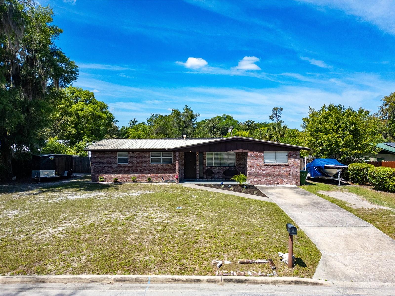 **HUGE LOT**POOL HOME**UPDATED** Welcome home to this charming and modern 3 bed/2 bath residence offering 1,530 sqft of NEWLY UPDATED living space. This TURNKEY property features an OPEN FLOOR PLAN and a second living room, all FRESHLY PAINTED throughout with NEW FLOORING and modern lighting fixtures. The gorgeous kitchen is a true standout, boasting quartz countertops, a butcher block island, and NEW APPLIANCES. Plus, the home includes spacious bedrooms with UPDATED BATHROOMS. Your outdoor getaway awaits on this 1/2 acre lot, featuring a LARGE IN-GROUND POOL with a resurfaced deck, new heater, and a new pump. Enjoy a MASSIVE SCREENED-IN PATIO and NEW HVAC (18 SEER). The property also includes tons of storage with TWO SHEDS, one 12x24 with electric. Centrally located near shopping, dining, and the St. Johns River, this home is the perfect blend of luxury and convenience! Schedule your showing today!