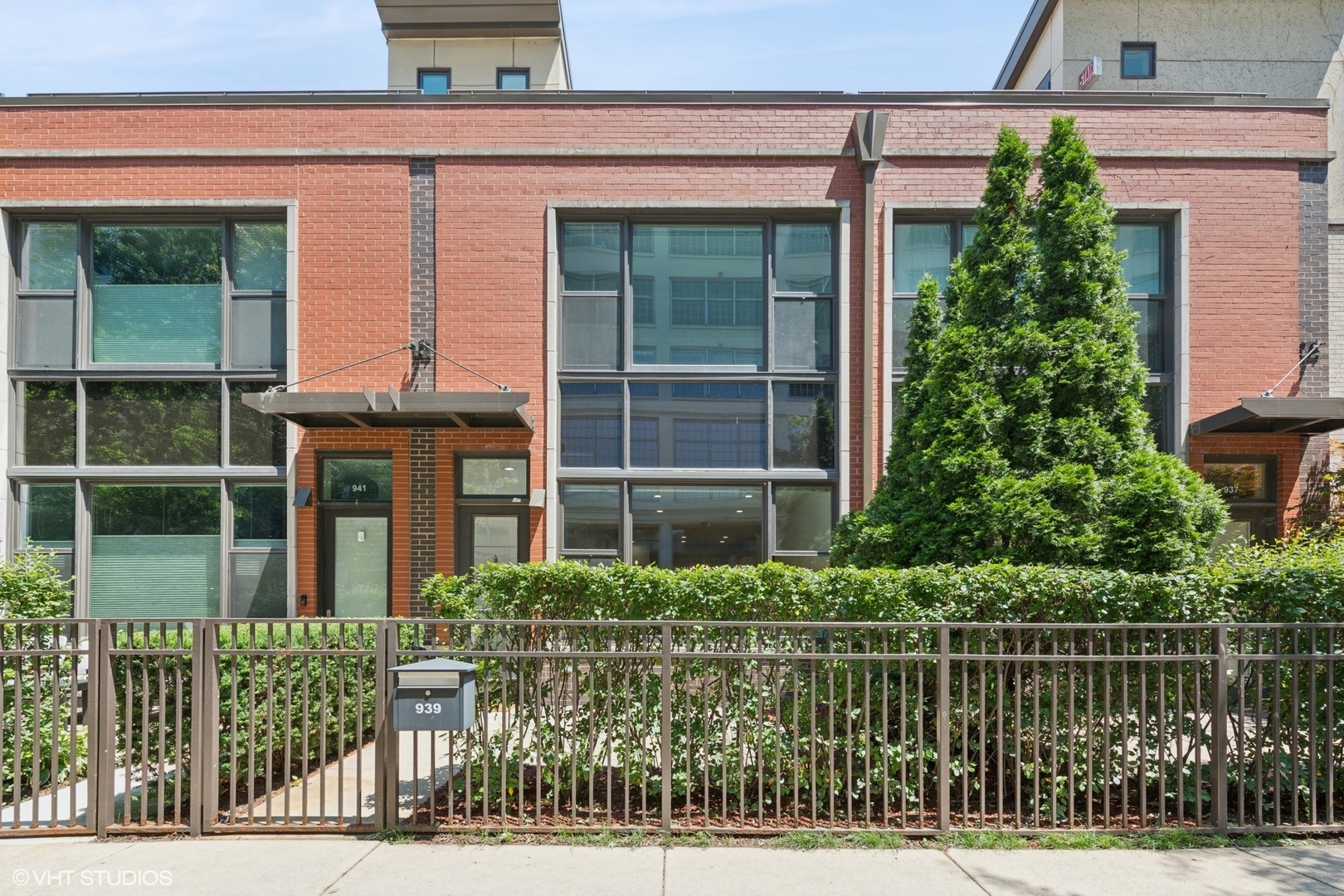 Tucked behind a charming front patio and timeless brick facade, this updated 2-bedroom, 2.5-bath townhome in River North offers the perfect blend of style, comfort, and location. Inside, the spacious main level features a sunlit living and dining area with high ceilings, newer hardwood floors and a striking fireplace surrounded by custom built-ins. The open-concept kitchen has been fully renovated with sleek white cabinetry, high-end stainless appliances, quartz countertops, and an eye-catching tile backsplash. Upstairs, the primary suite with a new, spa-inspired en suite bath featuring a double vanity and a walk-in shower with dual rainfall showerheads. The large second bedroom shows vaulted ceilings, a built-in Murphy Bed and additional storage within. The private rooftop deck, complete with newer herringbone pavers, offers an ideal space for summer lounging and entertaining under the Chicago skyline. Additional upgrades include a newer HVAC system, water heater, washer/dryer, brand new stair carpet and more. Located just steps from the Chicago River, green spaces, Newberry Library, Goose Island, and River North's best restaurants and shopping-this is urban living at its best.