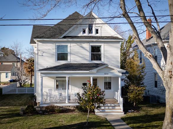 Southern exposure 3 story historic home on tree-lined Monroe Ave has been fully renovated & is impeccably kept. Home has 1.5 lots w/mature landscaping & alley access in back. Inside gleaming pine floors, generously sized rooms, tall ceilings & electric fireplace add timeless charm. Gourmet kitchen is filled w/ natural light & opens to bright & sunny dining area. The living room & great room offer abundant entertaining space. The spacious front porch is perfect for enjoying bay breezes & visiting w/ friends & neighbors. 4 bedrooms, 3..5 full baths which includes finished 3rd floor this Coastal Gem offers space, beauty, & an unbeatable location just a short walk to central park for Saturday night summer concerts, pickle ball, tennis & large playground. Walk to shops, restaurants & galleries.