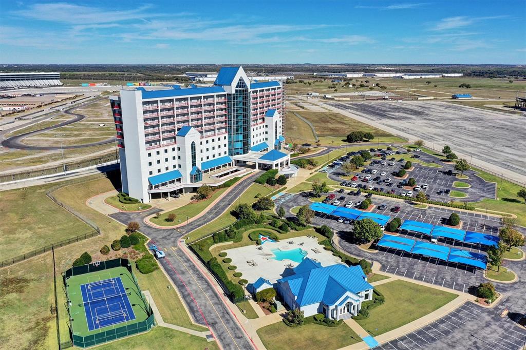 ALLIANCE CORRIDOR CONDO OFFICE  Discover luxury living with front-row views of Texas Motor Speedway! This fully renovated 2-bedroom, 3-bath condo on the PENTHOUSE level offers a stylish and comfortable retreat. Step inside to an open floor plan that flows seamlessly from the sleek, updated kitchen to a spacious living area, perfect for entertaining or relaxing. Expansive windows showcase prime views of the speedway and rooftop access to stadium seating to allow you to enjoy race day excitement right from home—a dream setting for motorsports fans!The gourmet kitchen boasts stainless appliances including a Viking Professional range, quartz countertops, and custom cabinetry, ideal for everything from quick meals to dinner parties. The primary suite features a walk-in closet and en-suite bathroom with a glass-enclosed shower, while the second bedroom offers versatility for guests or as a home office, with an en-suite bath.This vibrant community provides resort-style amenities, including a clubhouse, pool, hot tub, and a fully equipped fitness center. For sports enthusiasts, on-site tennis, basketball, and pickleball courts offer plenty of activity options. Whether you’re looking for a full-time home, a live-work arrangement or a weekend getaway, this condo combines excitement, relaxation, and convenience. Don’t miss this rare chance to enjoy an unbeatable view and luxurious lifestyle—schedule your tour today!Currently being used as a corporate office, so it can be residential or office space!