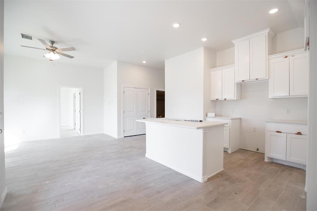 This John floor plan includes 1,310 Sqft of total living space, which includes 1,200 Sqft of indoor living space and 110 Sqft of outdoor living space. There is also a 385 Sqft, two car garage with a storm shelter installed. This new home offers 3 beds, 2 baths, 2 covered patios, and a utility room! The living room includes high ceilings, exquisite wood-look tile, a ceiling fan, the perfect sized windows, and Cat6 wiring. The kitchen spotlights custom-built cabinets with decorative hardware, stainless-steel appliances, decorative tile backsplash, elegant countertops, and wood-look tile. The primary suite features 2 windows, a ceiling fan, our cozy carpet finish, and a sizeable walk-in closet. Attached is the upgraded primary bath, which holds a dual sink vanity complimented by a 3 CM quartz countertop, satin nickel features, and a tub/shower combo. Outdoor living includes fully sodded yards, a smart home irrigation system, and 30-yr weather wood shingles. Other amenities include a water-saving tankless water heater, a fresh air intake system, R-15 & R-38 insulation, and so much more!