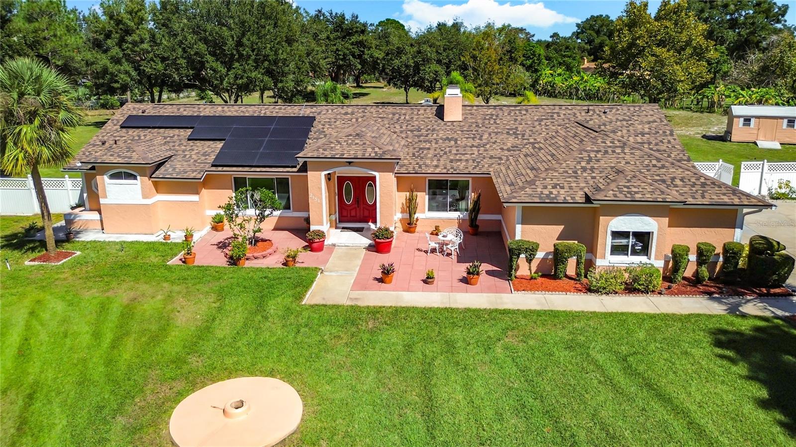 Your dream home just hit the market! Tucked away at the end of a quiet cul-de-sac, this stunning 5-bedroom, 3-bath retreat sits on an incredible 1.5+ acre lot—one of the most unique in the area! With a new roof and gutters (2025), HVAC (2023), and fully paid-off solar panels, this home blends comfort, efficiency, and peace of mind. Step inside to a freshly painted exterior, a cozy wood-burning fireplace, and a recently renovated owner's suite designed for pure relaxation. The open, light-filled layout invites connection and comfort, while the sprawling lot offers endless possibilities—build a second home, garden, or create your private backyard paradise. Plus, with no mandatory HOA, you have the freedom to make it truly yours. Enjoy the perfect blend of modern updates, space, and serenity—a one-of-a-kind Florida retreat ready to welcome you home.