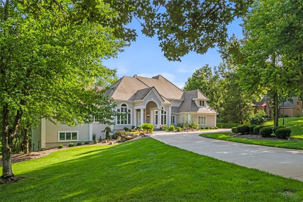 This awesome home is a show stopping family home and entertaining slice of paradise! This estate home is positioned on over 2 acres of manicured ground, touching over 600 ft of stunning fairway at the coveted Lakewood Oaks Country Club golf course.Completely remodeled with additions and added amenities, this home was fully transformed 2007-08. Over 10,600 sqft of indoor living and covered outdoor entertaining space with 4 kitchens, 9 total baths 4 gas fireplaces, private apartment bedroom, 1100 bottle temperature controlled wine room, spacious theater/game room with 4K theater projector, and so much more, makes this home your place to feel like you never have to leave and like you're on vacation every day! Your friends will marvel at your huge heated salt water gunite infinity edge pool completed with resort style waterfall over the built in grotto. Come home and relax after a tough day in your built in gunite hot tub/spa, or entertain in your covered outdoor kitchen, all on a fully floored flagstone walking areas, end to end. All of this outside backyard space overlooks a top design stone lined creek way that snakes its way across the back yard space. The Elan home automation system lets you control home lighting, pool, hot tub controls, security and other electronics from wherever you are. The homes interior boasts of living spaces and open concept spaces with ceiling heights 15 and 16'. No need to go to the gym when you have your spacious work out room right at home. The 6 car garage has epoxy coated flooring and has plenty of room for your cars and big boy toys! Viking appliances, double laundry areas, newer windows, some new and newer HVAC systems, lifetime concrete roofing system and more. There's no way to name everything in this home and property has. This home in the highly sought after KC community of Lees Summit, Mo. in the tremendous lake community of Lakewood, close to all KC amenities. Come see this breathtaking home!