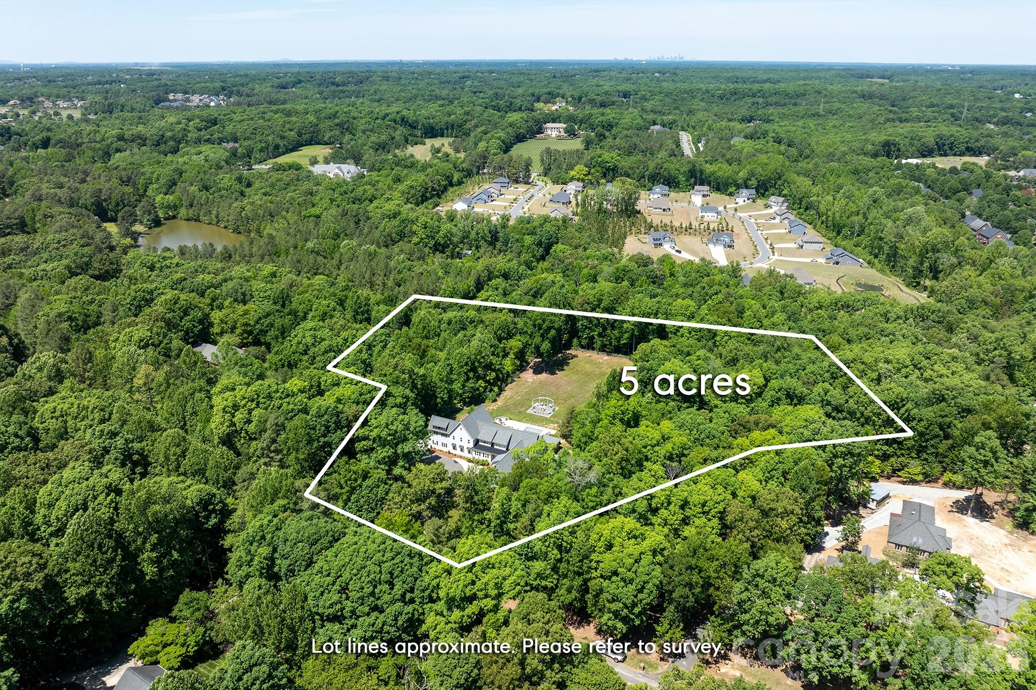 Set on five private acres in Marvin and zoned for the highly sought-after Marvin Ridge schools, this home offers more than 10,000 square feet of beautifully renovated living space. The chef’s kitchen is made for gathering, with two oversized waterfall islands, double refrigerators, premium appliances, and an expansive scullery. A dedicated garage bay provides direct access to the kitchen, making grocery runs that much easier.The flexible floor plan includes a primary suite on the main level and a second upstairs, along with four spacious upstairs en-suite bedrooms, a bonus room, two dedicated home offices, and laundry rooms on both levels. The upstairs primary suite features dual walk-in closets and a spa-inspired bath with a soaking tub and double vanities. Multiple living spaces continue into the finished walk-out basement, where you’ll find a home theater, gym, billiards area, and additional room to entertain or unwind.Outside, mature trees frame a resort-style retreat with a heated saltwater pool, hot tub, cabana, and full outdoor kitchen. Set on five private acres, the estate also features a four-car garage. New windows, a new roof, and updated major systems give this extensively renovated home the feel of new construction.