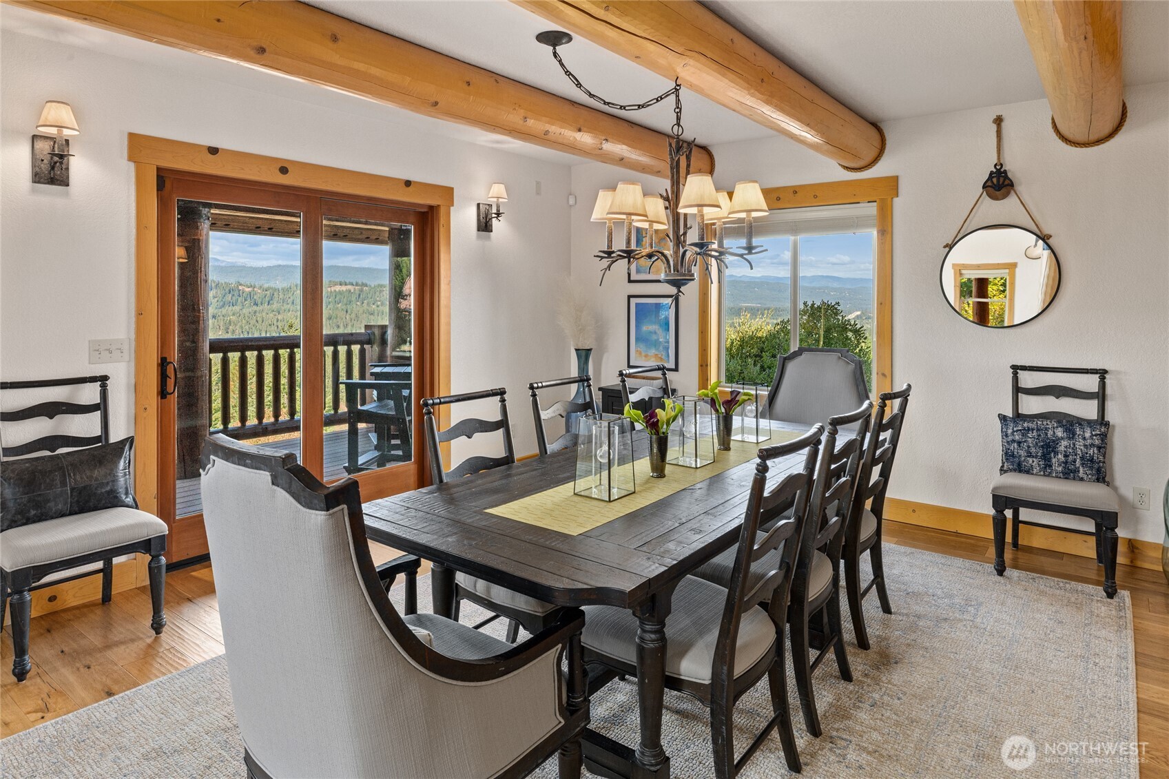 A generous dining space designed for gathering, with direct porch access and expansive views beyond.