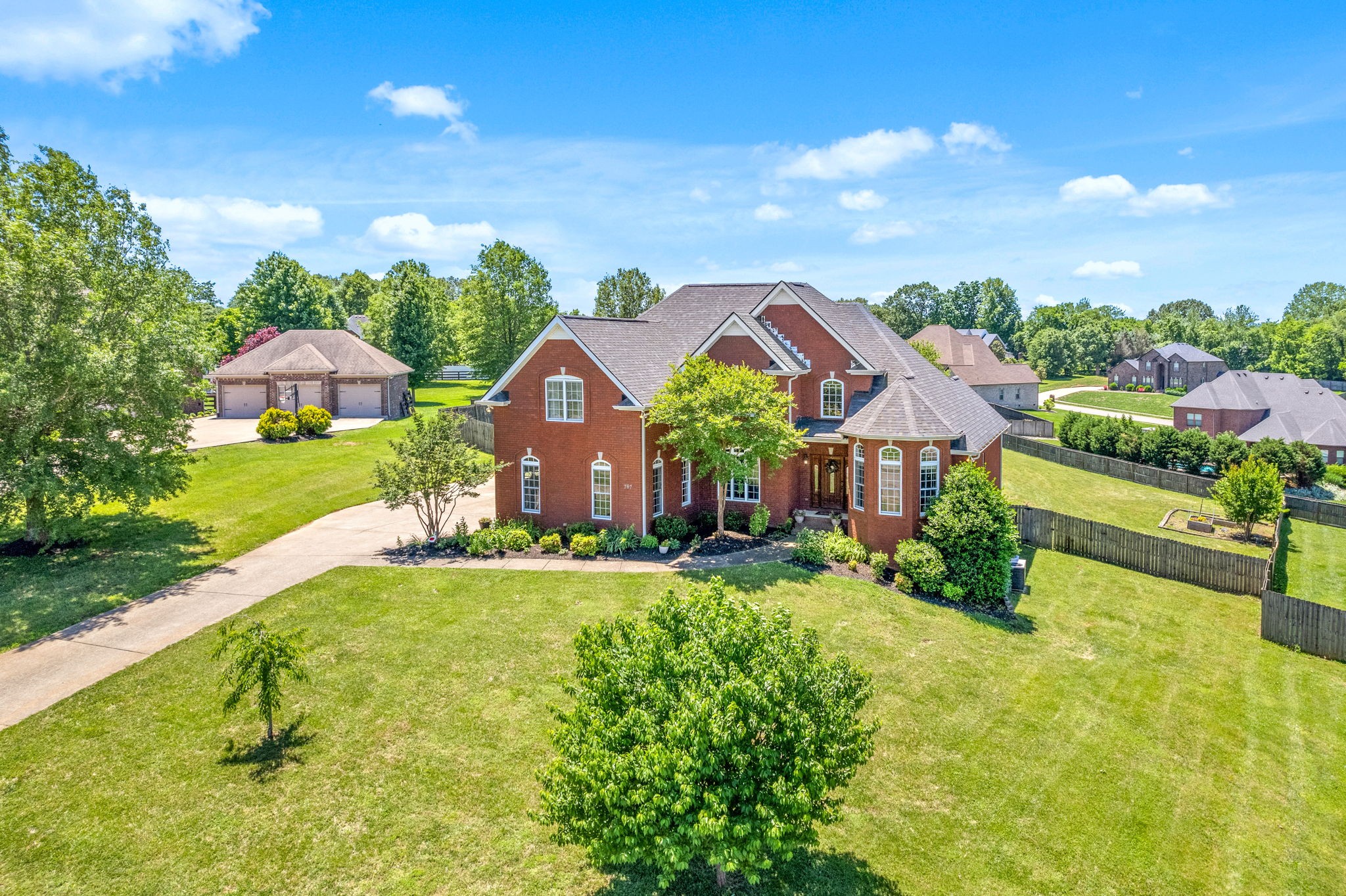 Stunning All Brick home in the highly desirable Harris Estates! Welcome to 767 Dixie Lane, a meticulously crafted residence nestled in tranquil Pleasant View, Tennessee. Conveniently located just mins from HWY 49 and I24 for an easy commute. This custom-built home offers 2,750 sq ft of luxurious living space, blending modern design with timeless elegance. Beautiful hardwoods throughout, brand new luxury tile in the chefs kitchen, featuring plentiful granite counter space, large center island, 2 pantries, custom cabinetry, with plenty of natural sunlight! The expansive open concept living area features vaulted ceilings, elegant open air staircase and wood burning fireplace/mantle creating a feeling of grandeur. The extravagant primary suite is located on the first floor for privacy, including a window seating area, architectural tray ceilings, double walk-in closets and ensuite bathroom. The primary bath is luxury at it's best, with a large garden tub, separate shower and toilet closet, plus his and her vanities! Your guest will also enjoy a first floor guest bedroom with full bathroom around the corner. 2 additional bedrooms upstairs featuring custom built rustic bunk beds sure to be the envy of any sleepover! Gigantic 20x20 bonus room over garage, plus an expansive 6x6 closet previously used as an office by residents. This home interior has way too much to list, it's a must see! The premium lot is one of the largest in the neighborhood at 1.13 acres, completely fenced backyard, raised garden beds, allocated mulched play area with playset and deck for entertaining guests! The standing crawlspace has a separate exterior entrance featuring plenty of extra storage for your mower and toys! Plus High Speed Fiber Internet! What more could you ask for!