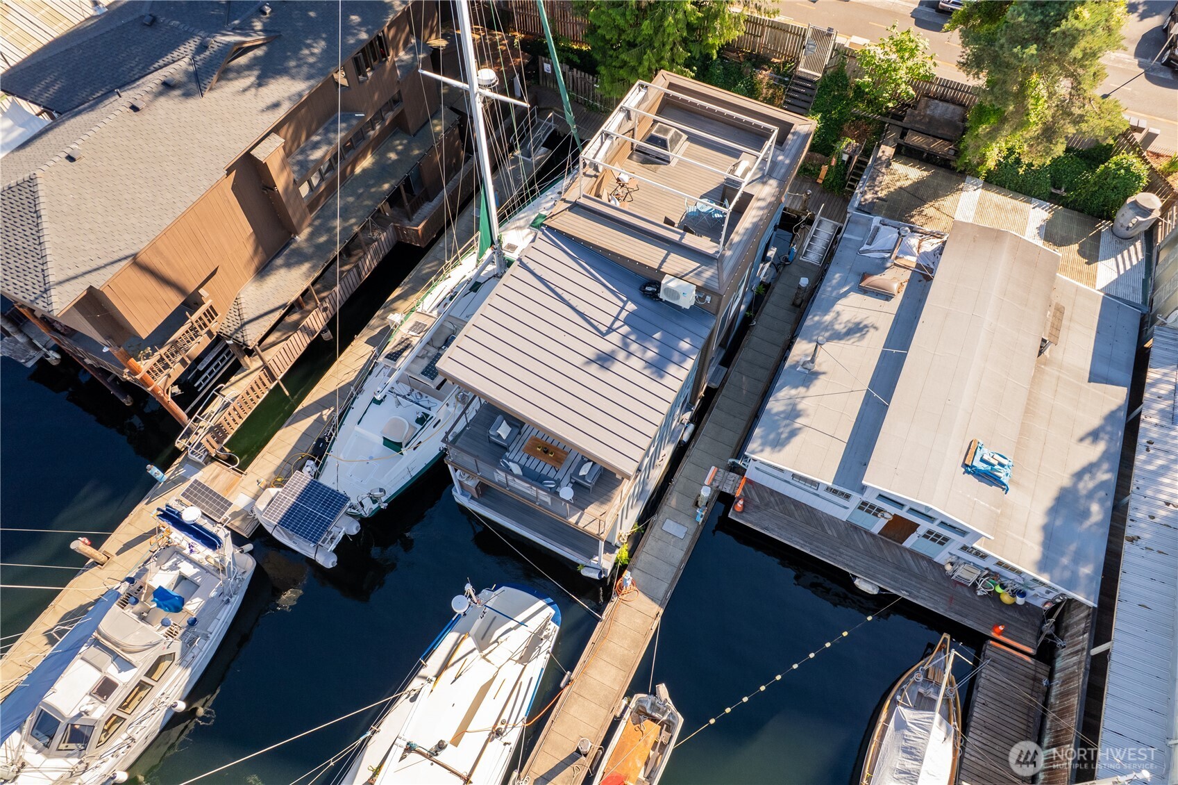 Solstice is a stunning modern houseboat located in the heart of Seattle in Lake Union's Westlake enclave. This contemporary luxury floating residence offers expansive windows, a sun-drenched open concept living space, & sleek architectural finishes throughout. The stylish kitchen flows seamlessly into the main living area, creating the perfect setting for relaxing or entertaining. Two large bedrooms & a tucked away office offer great spaces. Enjoy three private outdoor decks, including a spacious rooftop retreat w/ panoramic lake & city views - ideal for watching 4th of July fireworks. Just steps from the Lake Union Loop Trail, you are perfectly positioned to explore Fremont, South lake Union, and all the best of waterfront Seattle living.