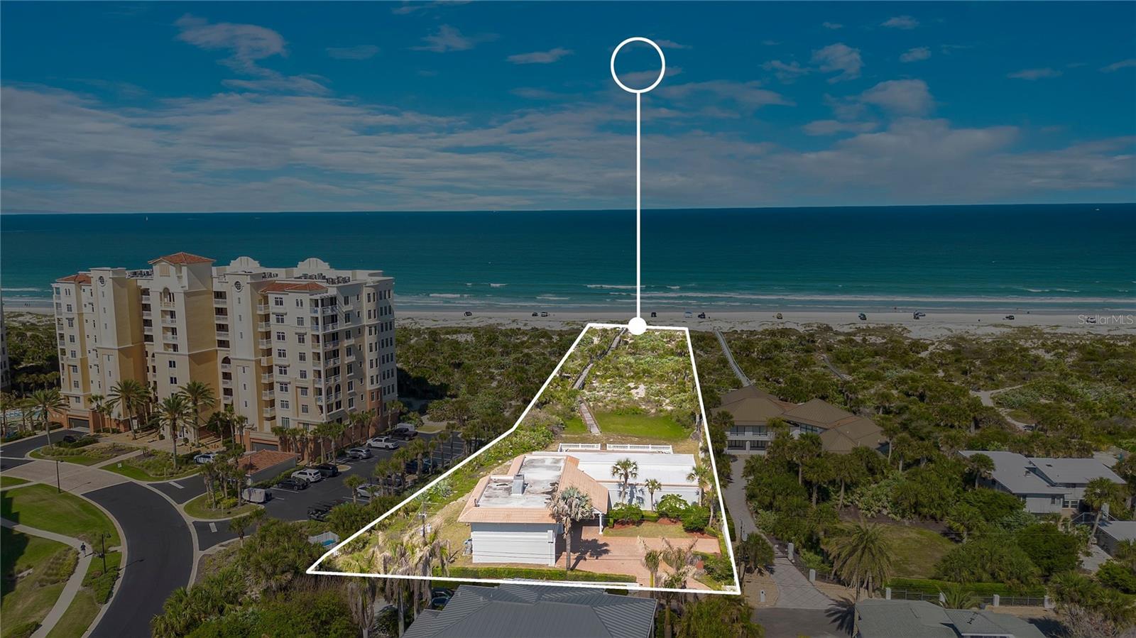 One or more photo(s) has been virtually staged. Villa Valentina Estate, an oceanfront experience like no other with timeless coastal luxury positioned on 1.5 acres of prime oceanfront land. This Private Estate presents a rare and valuable opportunity with plenty of land to build an additional guest house or custom addition. This exceptional offering seamlessly blends immediate luxury living with future development potential, making it one of the most versatile and coveted properties in New Smyrna Beach, where you can enjoy coastal elegance today while creating your vision for tomorrow.Nestled along the iconic and highly coveted North Beach shoreline, renowned for its world-class surf, this private estate stretches from Ocean Drive to the sand and surf. As the northernmost single-family oceanfront home before the inlet and dunes park, the property delivers exceptional privacy, panoramic Atlantic Ocean views, and a front-row seat to nature, including sea turtles nesting along the shore.Your 5-bedroom, 6-bathroom residence with a 3-car side entry garage is double deep along with lots of parking is designed for luxury and entertaining. Inside, you will find open-concept living areas, recently renovated bathrooms, and a dedicated media room. The chef’s kitchen features stainless steel appliances, a natural gas stove, and elegant crown molding, flowing into a spacious living room complete with a wet bar.Designed to feel like a private coastal resort, the home’s expansive patios, poolside setting, and venue-style layout make it ideal as a luxury residence, vacation retreat, or premier entertaining space. Expansive glass doors open to a covered, tiled porch with a full outdoor kitchen and built-in gas grill, creating seamless indoor-outdoor living. Multiple terraces, archways, and balconies capture breathtaking ocean views, while a 1,400-square-foot covered patio spans the length of the home, perfect for entertaining around your 36’ x 20’ saltwater pool and spa. The first floor offers approximately 3,000 square feet, including a full bedroom, 1.5 baths, and a striking double-sided fireplace separating the dining and living areas. Upstairs, 4 bedrooms each feature their own private bathrooms, the primary suite serves as a private retreat with its own oceanfront balcony, ideal for morning coffee or sunset views. The spa-like ensuite includes a double vanity, walk-in shower, and an expansive walk-in closet. Located in the heart of New Smyrna Beach, known as the surfing capital of Florida, you are just moments from world-class waves near the jetties, fishing at Ponce de Leon Inlet, the lagoon, and a vibrant coastal lifestyle filled with waterfront dining, boutique shopping, and local art. Whether you are expanding, investing, or simply enjoying oceanfront living at its finest, Villa Valentina offers a truly unmatched opportunity with NO HOA. Be sure to click on the virtual tour links.