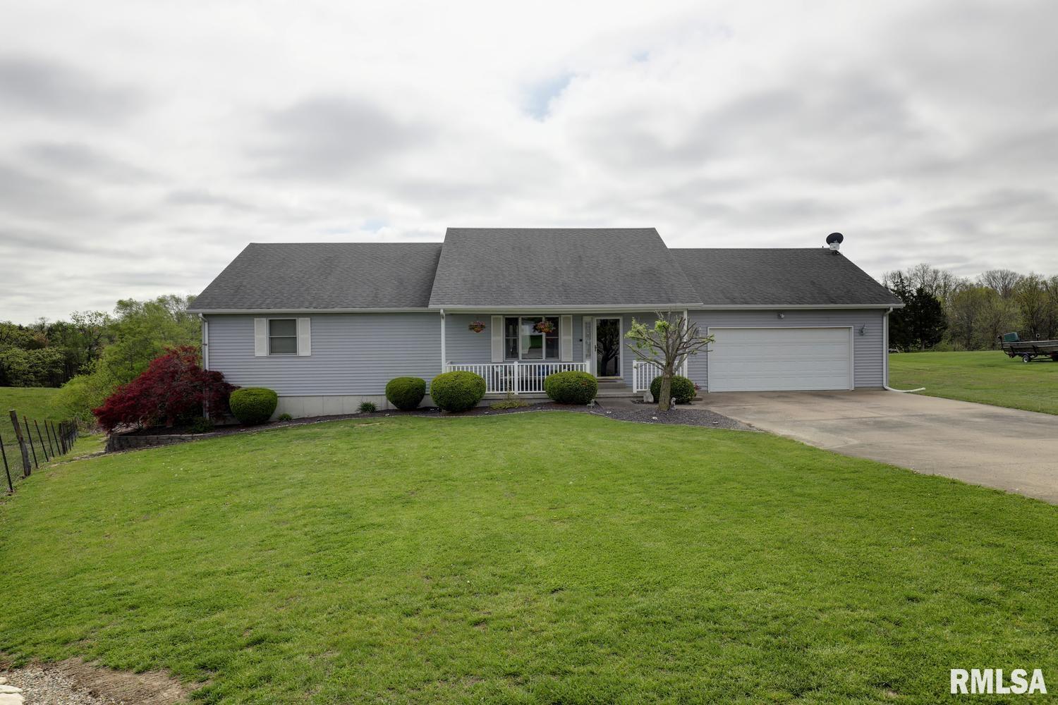 Enjoy the best of both worlds at 2256 N 956th Ave in Liberty—quiet country views with the feel of a small neighborhood. This well-kept home offers 2-4 bedrooms, 3 baths, and 2,950 sq. ft., with a bright main level, spacious kitchen and living areas, and a screened porch overlooking the yard. The finished lower level adds valuable flexible space, while the attached garage and manicured setting complete the package. With the house situated on 3/4 acres and the additional 2.73-acre parcel, this property delivers room to breathe and room to grow. The buyer of the house will have right of first refusal on the acreage. New roof to be installed before closing (buyer may still have time to pick shingle color). Subject to sellers closing on specific housing. The 2.75 acre lot to the east of the home is also for sale.