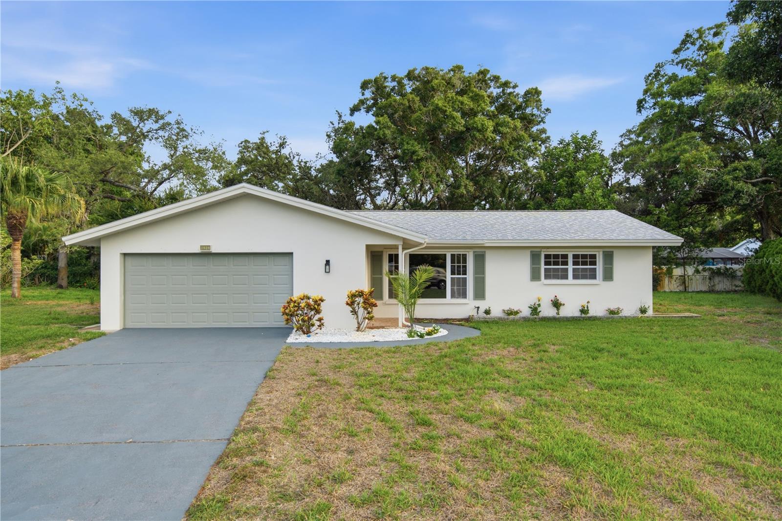 Welcome to Dunedin, one of Tampa Bay’s most beloved coastal communities, where small-town charm, Gulf Coast beauty, and an active local lifestyle come together. Tucked at the end of a quiet cul-de-sac, this newly renovated 3-bedroom, 2-bathroom home offers nearly 1,500 sqft of living space, a spacious 2-car garage, and a generous quarter-acre lot. No expense was spared in the thoughtful renovation of this move-in-ready home. Stepping inside, luxury vinyl plank flooring flows throughout the open-concept floorplan. The living room transitions seamlessly into the dining area and beautifully redesigned kitchen, creating an inviting space for everyday living and entertaining. The kitchen stuns with quartz countertops, a waterfall-edge peninsula, brand-new stainless steel appliances, two-tone cabinetry, and a gorgeous backsplash extending from the countertops to the ceiling.Both bathrooms have been thoughtfully remodeled with quartz countertops, modern vanities, arched mirrors, and coordinating brushed-gold fixtures. One bathroom features a tub and shower combination surrounded by elegant floor-to-ceiling tile with a decorative niche, while the second showcases a spacious walk-in shower finished with contemporary designer tile. A dedicated laundry room provides additional storage and a modern utility sink.Major improvements include a new roof completed in 2022 and a new electrical panel installed in 2026, offering added peace of mind. From this convenient location, you can take your golf cart into vibrant Downtown Dunedin to explore locally owned restaurants, breweries, boutiques, waterfront parks, festivals, and the popular Downtown Market. Spend the day biking the Pinellas Trail, playing a round at the historic Dunedin Golf Club, catching a spring training game at TD Ballpark, or heading to the Dunedin Causeway and Honeymoon Island for kayaking, beach days, and unforgettable sunsets. Caladesi Island, Hammock Park, Clearwater Beach, shopping, and everyday conveniences are also within easy reach.Whether you are searching for a full-time residence, seasonal escape, or opportunity to enjoy the laid-back Florida lifestyle, this beautifully renovated home places you close to everything locals love about living in Dunedin. Schedule your showing today!