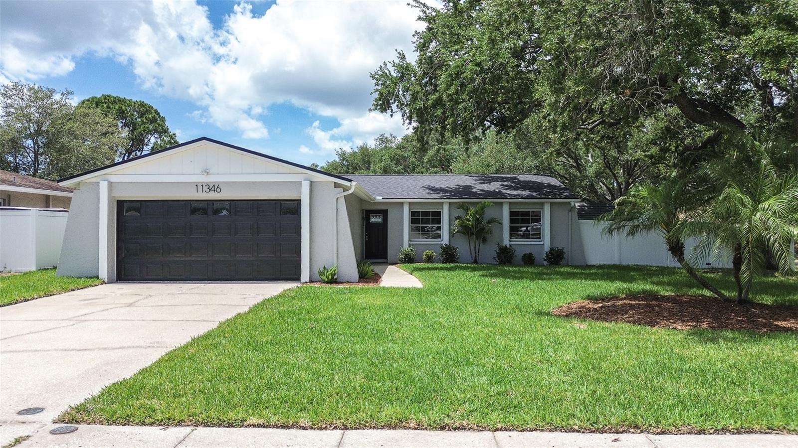 One or more photo(s) has been virtually staged. Completely remodeled from top to bottom, this stunning 4-bedroom, 2-bath home in the highly desirable Autumn Run neighborhood is truly move-in ready. Every detail has been thoughtfully upgraded, featuring all-new luxury vinyl plank flooring throughout, complemented by modern 5.5-inch baseboards and stylish two-panel interior doors. The home has been freshly painted inside and out, creating a bright, clean, and contemporary feel. The brand-new kitchen is a showstopper, offering soft-close cabinetry, sleek quartz countertops, and stainless steel appliances—perfect for both everyday living and entertaining. Both bathrooms have been fully renovated with tasteful, modern finishes. Major updates provide peace of mind, including a brand-new roof installed in January 2026. The home also features a spacious and meticulously maintained two-car garage. Situated on a large corner lot, the outdoor space is just as impressive, with a fully fenced yard featuring white vinyl fencing, a sprinkler system, and a screened-in patio complete with a hot tub—ideal for relaxing or hosting guests. This beautifully updated home combines quality craftsmanship, modern design, and an unbeatable location. Don’t miss your opportunity to own a turnkey property in Autumn Run!