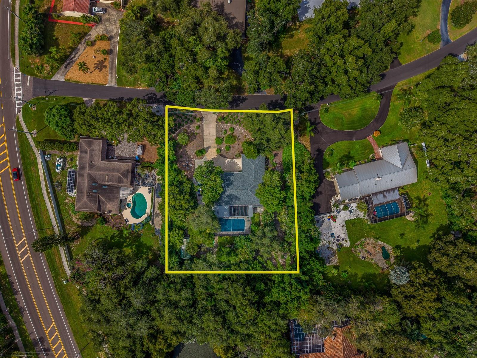 Welcome to 3 Birdie Ln, Palm Harbor, FL 34683—a distinctive 4-bedroom, 3-bath estate home situated on .78 acres in desirable Gulf View Estates, just down the road from Honeymoon Island. With expansive outdoor living, a solar-heated pool, thoughtful upgrades, and an impressive lot, this property offers a rare opportunity to enjoy the Palm Harbor lifestyle.Custom stained glass near the front entrance creates a memorable welcome, while plantation shutters on all windows and tile flooring throughout bring timeless style and everyday practicality. The living room and kitchen combination provides a comfortable gathering space, complemented by a separate formal dining room. Generous storage in and around the kitchen and throughout the home keeps daily essentials conveniently within reach. A propane-fueled fireplace adds warmth and character.The split-bedroom layout places the primary suite in the south wing, offering abundant closet space and private access to the pool area. Three additional bedrooms occupy the north wing, with a Jack-and-Jill arrangement providing flexibility for family and guests. A dedicated laundry room is located in the west wing.Outdoor living takes center stage with a 15’ x 30’ covered patio, hot tub, and chlorinated pool heated by a solar system installed in 2023. A pocket door opens to the pool area, creating an inviting connection between indoor and outdoor spaces—ideal for entertaining or relaxing in your own Florida retreat.Beautiful Florida-native landscaping and a butterfly garden enhance the grounds, with xeriscape elements adding natural appeal. The spacious driveway offers ample room for vehicles, a boat, or recreational toys, while a 12’ x 20’ shed with electricity provides valuable space for storage, hobbies, or projects. A hurricane-rated garage door adds another practical upgrade.Major improvements include a new roof in 2021, a new HVAC system in 2025, and updated windows throughout. With major components upgraded over the years and modest aesthetic updates, this home offers comfortable living today and the opportunity to personalize its finishes to your taste.Enjoy proximity to Honeymoon Island State Park, Gulf beaches, the Pinellas Trail, and Palm Harbor’s dining, shopping, and recreation. Estate-sized grounds, a private pool retreat, and a sought-after Gulf View Estates setting make this Palm Harbor home a must-see. Opportunities like this do not come along often—schedule your private showing today!