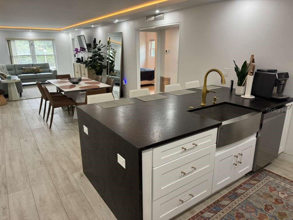 WELCOME TO A BEAUTIFULLY FULLY RENOVATED AND FURNISHED CONDO IN THE WATERFRONT NEW ATLANTIS CLUB COMMUNITY! This residence has been completely renovated from top to bottom, offering a fresh, modern interior and a truly move-in-ready opportunity.Step inside to a bright and inviting living space featuring updated finishes throughout, a beautifully renovated kitchen, remodeled bathroom, new flooring, fresh paint, updated fixtures, and carefully selected details that create a clean and contemporary feel.Enjoy the Florida waterfront lifestyle with convenient space for your kayak and direct access from the community grounds to the Intracoastal Waterway, making it easy to enjoy kayaking, paddleboarding, fishing, and days on the water. The waterfront setting in the back of the community provides beautiful views and access to the waterways leading toward the Gulf.New Atlantis Club offers resort-style amenities including heated swimming pools, hot tub, fitness center, clubhouse, grilling and picnic areas, and beautifully maintained common grounds.Conveniently located just minutes from  Beach, local restaurants, shopping, parks, and everything the Gulf Coast has.Whether you are looking for a primary residence, seasonal Florida retreat, or low-maintenance coastal property, this fully renovated condo offers an excellent opportunity to enjoy the Florida lifestyle. Schedule your private showing today!