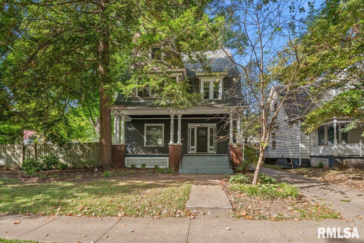 WESTSIDE NEIGHBORHOOD ASSOCIATION LEAVERTON HOUSE BUILT IN 1906. This is an amazing historical 5-6 bedroom 2 bath home in great condition located on an extra large lot with street and alley access and your own private parking pad next to the 2 car detached garage. You will love the abundance of hardwood floors, 3 working pocket doors, 3 working fireplaces (2 woodburning and 1 electric) and updated kitchen and baths. Improvements include: Roof and chimney tuckpointing approx 15yrs,  AC and condenser for 2nd and 3rd floor and 1st floor kitchen 2024, Washer 2023, Dryer 2021, as well as the plumbing and electrical and the 2nd and 3rd floor windows and the attic insulation 2002, restoration of the carriage house/detached garage with loft 2002, and much more. Ask your Realtor for a complete list of updates and information on the home and while your at it have them schedule a tour for you to check out this incredible home for yourself.