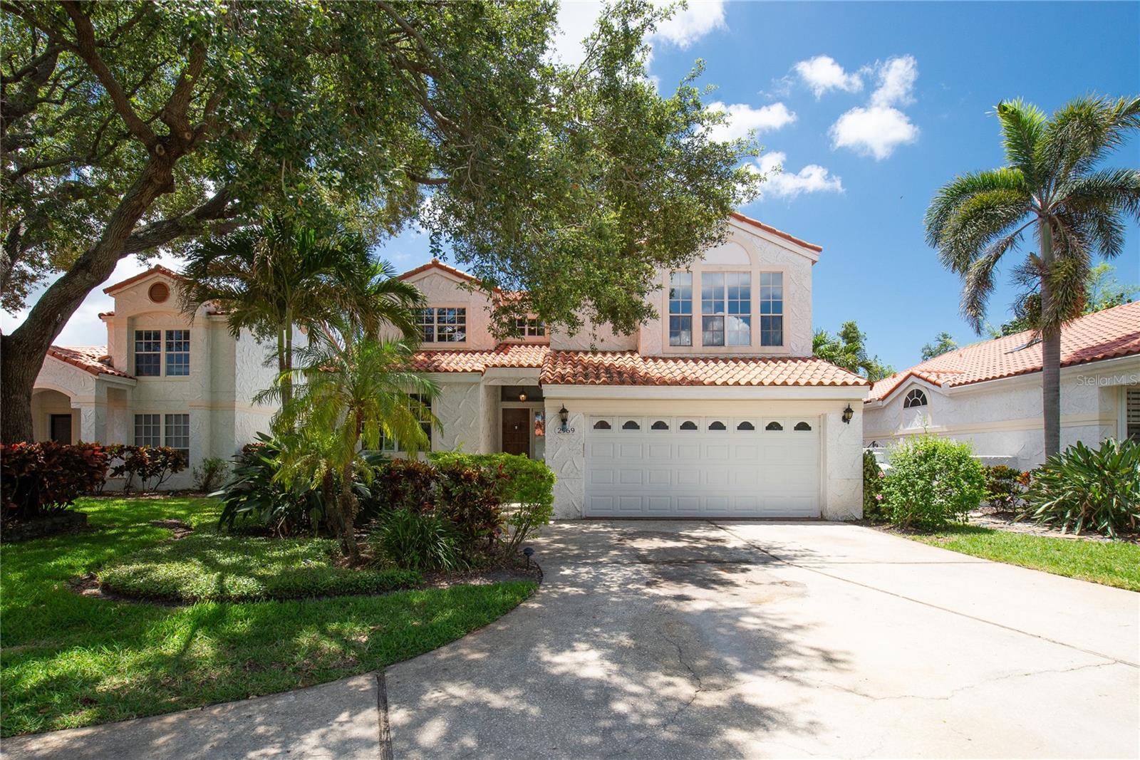 RARE FIND! THIS MEDITERRANEAN POOL HOME HAS IT ALL – LOCATION, LUXURY & LIFESTYLE! Nestled in the highly sought-after Vizcaya community of Feather Sound, this beautiful 2-story Mediterranean-style salt water pool home offers elegance, space, and comfort with 3 bedrooms, 2 bathrooms, a den, 2 car garage and 2,383 sq. ft. of living space (3,236 sq. ft. total), this home sits on a 7,018 sq. ft. lot on a quiet cul-de-sac with no rear neighbors. Designed by Arthur Rutenberg who was ahead of this time, this home feels modern, from the first moment you step inside. Be wowed by 20-foot ceilings, large windows allowing lots of light, durable ceramic plank tile floors in the living area and custom shades on all windows. The Mexican Saltillo tile adds warmth and character to a spacious kitchen, that was remodeled with level 5 granite countertops, stainless steel appliances and travertine backsplash. Enjoy a large center island with bar seating and extra storage—perfect for entertaining! The open-concept living and dining areas offer seamless access to the covered lanai and backyard oasis with luxury outdoor furniture that convey. Enjoy family meals with pool views, or host fun gatherings with the fully-equipped outdoor kitchen with propane grill and of course cozy evening with wood-burning fireplace. The screened-in pool area includes a large salt water pool, jacuzzi, waterfall, and sun shelf, ideal for lodging or safe play for your family. Downstairs you'll find a guest bedroom and full bath, while upstairs, the primary suite boasts 9-foot ceilings, double doors, hardwood floors, a spa-like bathroom with river stone vessel sinks, granite countertops, a jacuzzi tub with travertine walls, walk-in shower, and a massive walk-in closet. A second upstairs bedroom currently serves as a home theater, complete with a projector, screen, and surround sound—all equipment conveys. The spacious den could easily be converted into a 4th bedroom or used as a home office. Additional highlights includes red clay tile roof 2016, both A/C unit are 2016 but well maintained and serviced, brand new pool pump and plumbing (2025), private fenced yard, updated sprinkler system. The Association fees are $220 per month. The location is just perfect - minutes from I-275, Tampa International Airport, short drive to Downtown St. Pete, and the Beaches, in walking distance to Feather Sound Country Club, offering golf, tennis, swimming, and year-round events in one of the Bay Area’s most beautiful and walkable communities. This is more than a home – it’s a lifestyle. Schedule your showing today!