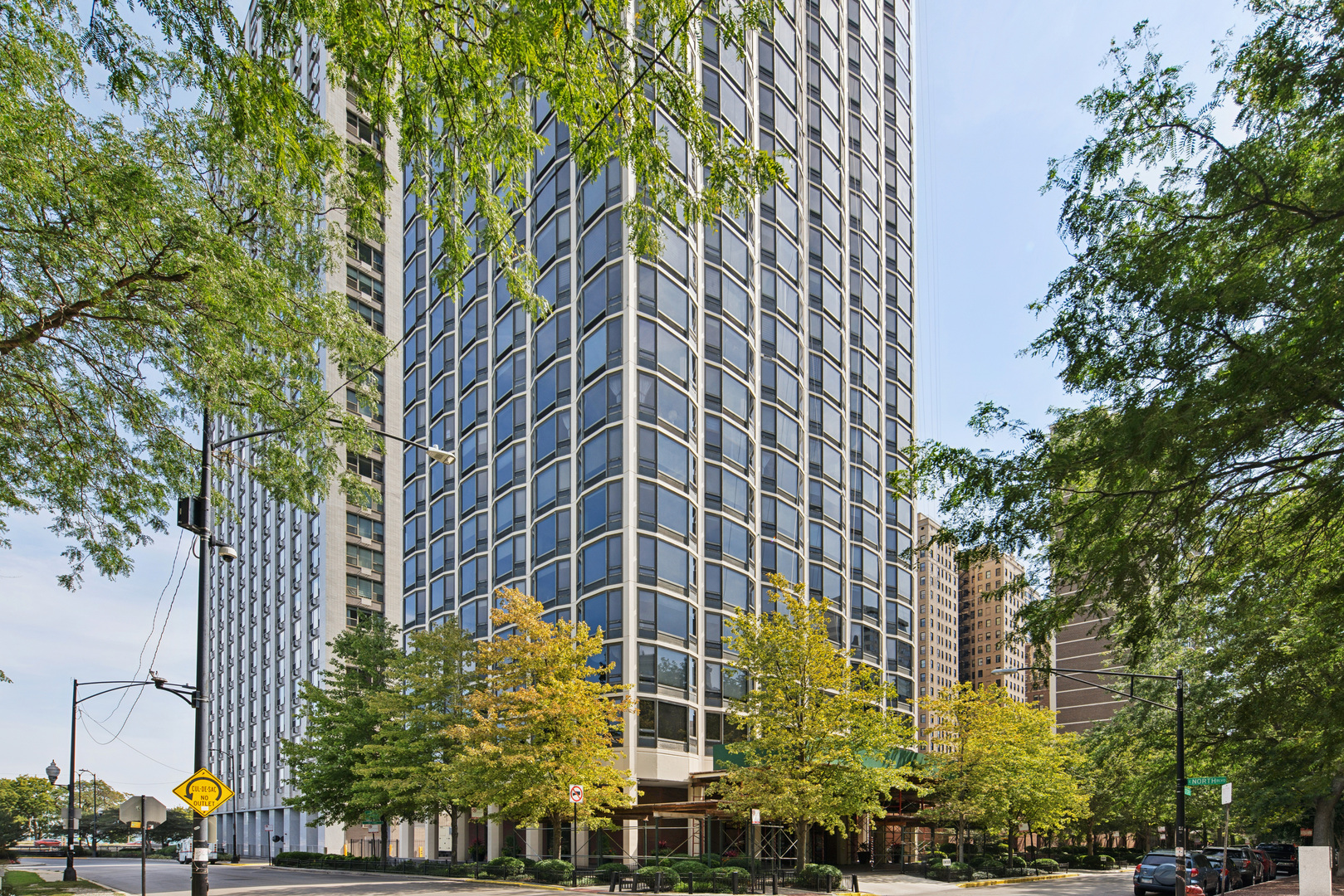 Enjoy Gold Coast living at 1555 N Astor-a premier high rise located on a cul-de-sac across from Lincoln Park and adjacent to Lake Shore Drive on one of Chicago's most prestigious streets. This 2 bedroom 2 bath southeast corner unit offers an exceptional living experience with breathtaking views of Lake Michigan to the east and vibrant city and skyline view to the south. The spacious floor plan boasts a large living room and adjacent dining room with new wood flooring-perfect for entertaining. The generous, renovated, eat-in kitchen features tons of cabinet space and storage, higher-end built-in appliances and an induction cooktop--not to mention an incredible view. This home boasts a split floor plan with two sizeable bedrooms and renovated baths. Plenty of storage including a large walk-in closet in the primary bedroom. A utility closet houses new, full-sized stackable washer and dryer and additional storage.  With only 3 units per floor, 1555 offers residents the feel and services of a boutique building with all of the advantages of a large luxury high rise including 24-hour door staff, pickleball/tennis courts, indoor heated pool, fitness room, sauna, sun-deck, grilling area and laundry room.  On-site professional management. Valet parking is readily available for a reasonable monthly fee, plus there is free daytime guest parking and a car wash service.  Walk to the best of the Gold Coast, Old Town, Lincoln Park and the shopping, dining, entertainment and transportation that is offered.  Your new dream home awaits!