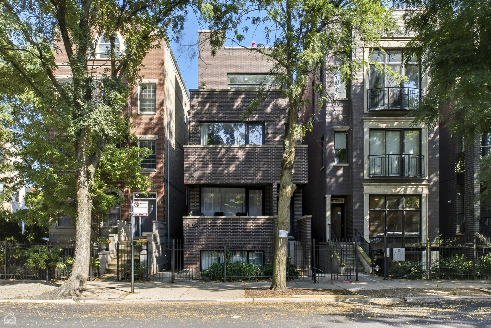 This incredibly stylish and modern 2-bedroom, 2-bathroom bi-level home in the heart of East Village/West Town offers the perfect blend of design, comfort, and location. Nestled in one of Chicago's most walkable neighborhoods, you'll find yourself just steps from vibrant restaurants, cozy coffee shops, and trendy boutiques, with all the charm and convenience of city living right outside your door. The thoughtfully designed layout includes two sizable private outdoor decks-one off the family room, ideal for entertaining guests, and another off the primary suite, perfect for relaxing with a glass of wine after a long day. Inside, the spacious family room makes a bold statement with soaring 11-foot ceilings, an eye-catching designer Sputnik-style chandelier, a full wall of custom built-in cabinetry and shelving, and a beautiful wood waterfall countertop. Natural light pours in, creating a bright and welcoming space that flows seamlessly to the private deck. The kitchen has been updated to perfection, featuring rich midnight blue cabinetry with brushed gold hardware, accent lighting, a dual-basin sink, a sleek tiled backsplash, quartz countertops, and stainless steel appliances. A smart built-in system adds both style and function with dedicated storage for flatware, cookware, and wine glasses. The hall bathroom is equally impressive, with a stunning mosaic inlay of grey, green, and blue tones, white marble surround, a floating vanity with a vessel sink, and a walk-in shower that exudes modern elegance. The bright and airy primary bedroom offers a wall of windows, a large walk-in closet, private outdoor space, and an impeccably updated en-suite bathroom. This spa-like retreat features a deep grey dual-sink vanity with textured basins, white quartz countertops, porcelain 12x24 floor tiles, marine blue and grey subway tile surround, and a custom three-panel lighted mirror-each section hiding spacious medicine cabinets for added convenience. Additional highlights include hardwood flooring throughout, abundant in-unit storage, generous closets, and a covered garage-operated carport that is deeded with the property. This exceptional home is truly move-in ready and offers the perfect opportunity to enjoy upscale city living in one of Chicago's most desirable neighborhoods.