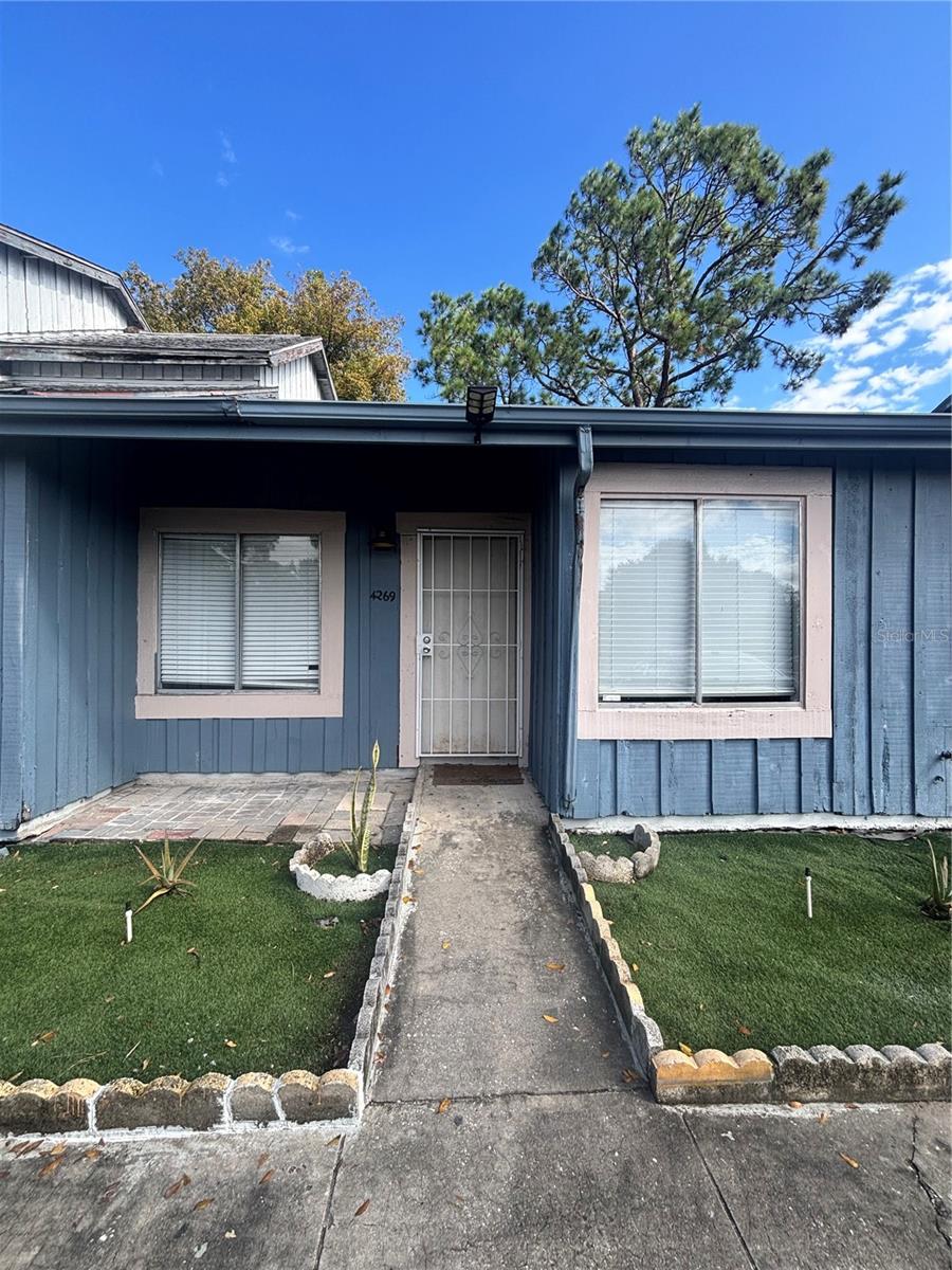 Here is your opportunity to own a updated 2 bedroom 1 bathroom condo with an indoor laundry room, ceramic tiles throughout, fresh paint and updated lighting fixtures. Your kitchen boast a subway tiled backsplash, updated cabinets, updated appliances and new sliding doors that lead to your fenced in back patio. The private fenced in back yard is perfect for entertaining and relaxing.  New electric water heater installed in Nov. 2025 and new AC installed in 2022. Don't miss your opportunity to own an affordable home. Conveniently located approximately 30 minutes away from Disney and minutes from I-4. Call now to schedule your appointment soon.