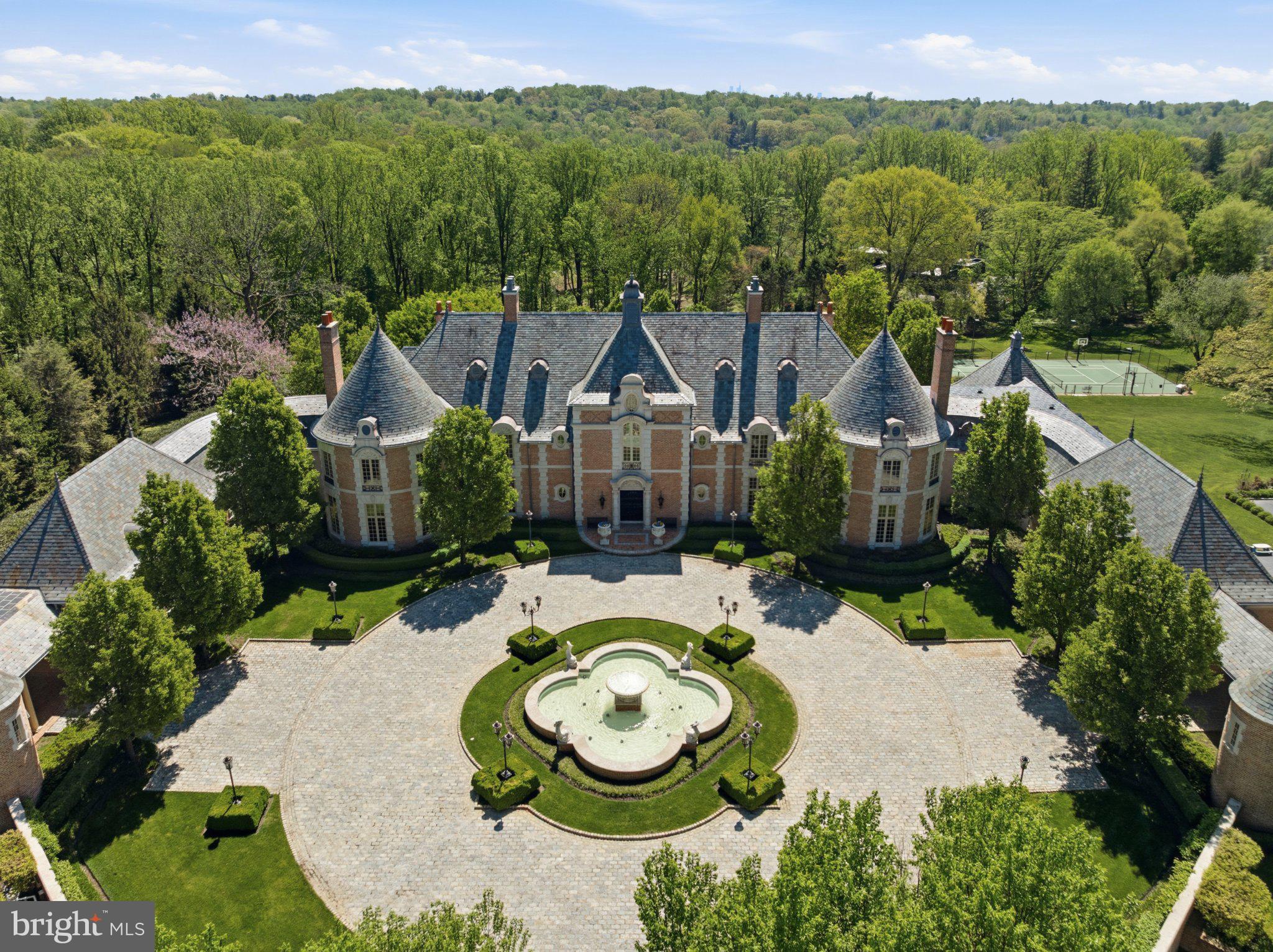 One of the most remarkable compounds built on the Main Line in the 21st century.Set across nearly 7.5 private acres of exceptionally manicured grounds just minutes from the Village of Gladwyne, this remarkable gated estate is fully fenced and designed for both privacy and security.Beyond the gates, a breathtaking fountain and cobblestone motor courtyard create a striking arrival, setting the tone for this stately brick and limestone residence defined by scale, craftsmanship, and refined design.Inside, the sense of scale and space is unrivaled. The grand foyer opens to a dramatic gathering space with soaring 30-plus-foot ceilings, abundant natural light, and sweeping views of the surrounding grounds. An elevator services all levels, supporting effortless multigenerational living, while a separate service entrance provides discreet functionality.The first floor is designed for both grand-scale entertaining and intimate gatherings. A sophisticated wine tasting room is perfectly positioned adjacent to the dining room, while the formal entertaining spaces provide an elegant setting for celebrations with family and friends. The two-story family room, complete with a fully functional bar, opens seamlessly to the breakfast room and kitchen.At the heart of the home, the oversized gourmet kitchen is appointed with tailored cabinetry, premium appliances, onyx countertops, and a fireplace, with sweeping views of the rear grounds, gardens, and tennis court. Bespoke finishes and thoughtful design make the space equally suited to everyday living and entertaining. A first-floor theater comfortably accommodates more than 20 guests, creating an exceptional setting for movie nights and gatherings.The finished lower level extends the home’s lifestyle offerings with a private wellness center, barber shop, game room, and two-lane bowling alley. These spaces transition seamlessly to the resort-like pool area, complete with a full outdoor kitchen, cabana, bathroom, changing rooms, outdoor shower, and expansive terraces designed for effortless indoor-outdoor living.Recreational amenities include a lighted tennis and sports court and a private two-lane bowling alley, offering a level of entertainment rarely found in a residential setting. Three guest houses provide flexible accommodations for extended family, guests, or staff, while a nine-car garage offers exceptional convenience and storage.A dedicated primary suite wing creates a private retreat, complete with its own sitting room, kitchenette, and outdoor seating area. His-and-hers marble and onyx bathrooms and dressing areas further elevate the suite, offering an exceptional sense of luxury, space, and privacy.Throughout the estate, beautifully landscaped grounds balance expansive lawns with intimate garden spaces, creating a setting that feels both grand and serene. Every element has been thoughtfully considered to support a lifestyle centered around privacy, entertaining, recreation, and multigenerational living.A truly exceptional Main Line compound, this estate offers an extraordinary combination of scale, amenities, craftsmanship, and privacy in one of Gladwyne’s most coveted settings.
