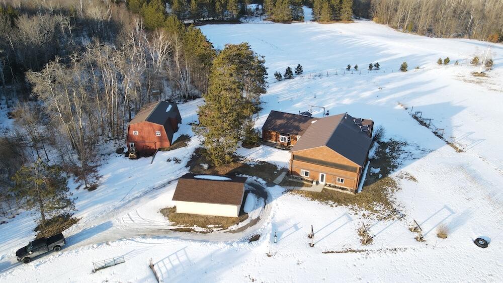 Discover this exceptional 4-bedroom, 2-bath home with over 3,500 sq. ft. of finished living space, set on 17 acres of prime country land, perfectly suited for horse lovers, outdoor enthusiasts, or anyone seeking privacy and tranquility. The property features a 3-acre hay field, pasture around the house, and a red pine stand, offering both beauty and function for a hobby farm or nature lover.This home is plumbed and ready for power, but electricity would need to be run throughout the home, giving the buyer the opportunity to wire it to their own specifications. The price has been set aggressively, well below the recent appraisal, to allow for this work to be completed to the new owner's specifications. Inside, enjoy bright, open living spaces, a functional kitchen and dining area, and a partially finished walk-out basement ideal for a family room, recreation, or storage. Wood heating, plus a propane water heater, provides year-round comfort.