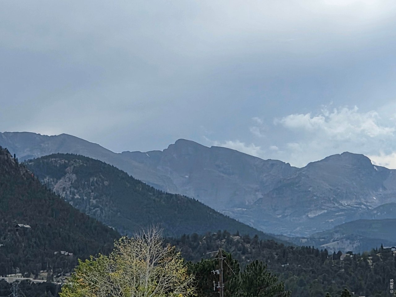 End unit! Welcome to this desirable, bright and open 3 bedroom, 2 bath, 2 car garage Ranch Meadow unit finished with natural wood accents and live edge beams. Located in the heart of Estes Park with quick access to Highway 34, Lake Estes, schools and more. High vaulted ceiling in the living room draws your eyes to the large windows facing the gorgeous mountain range, Lake Estes and twinkling of the city lights at night, not to mention the abundance of wildlife that passes right through the association. Open floorplan offers a spacious environment for you, yours and entertaining. Main level convenience with primary bedroom, ensuite bathroom, kitchen, laundry and living space with no stairs. The upper level has 2 more additional bedrooms, full bathroom and loft space. The loft is functional as an office, play room or exercise space. The second bedroom also has a large 7x7 closet for all your extras, or an additional workspace with ultimate privacy. Gas fireplace that flicks on with a switch, no messy wood! Built in humidifier to the forced air system. No special assessments, and a low monthly HOA fee. Welcome to your new home in Ranch Meadow! Schedule your showing today before this great opportunity is gone!