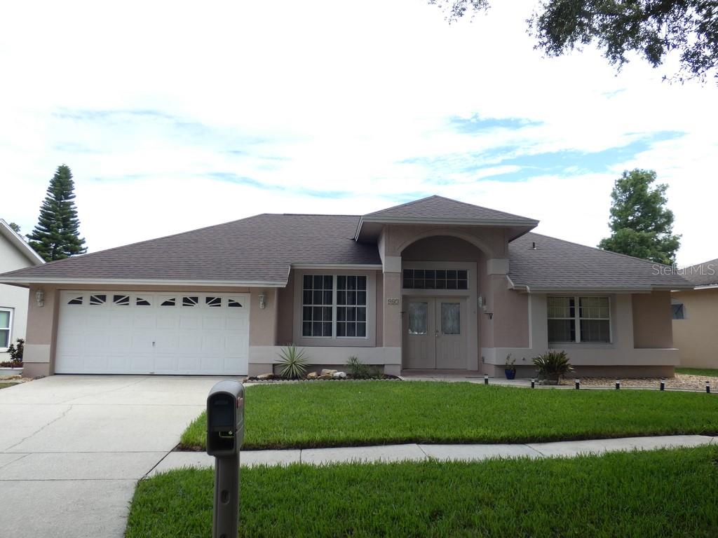 This 4-Bedroom, 2-Bath Block Pool Home Offers 2,091 Square Feet of Living Space. Built in 1990, the Home Features a Two-Car Garage and a Private Screened Swimming Pool. The Home Features Cathedral Ceilings, Formal Living and Dining Rooms, and a Spacious Family Room That Opens to the Kitchen. The Kitchen Includes a Coffee Bar, While the Primary Suite Offers a Walk-In Closet and Direct Access to the Pool Area. Multiple Sliding Glass Doors Provide Plenty of Access for Everyday Fun, Creating Seamless Indoor-Outdoor Living. The Fenced Backyard Includes Artificial Turf, a Recently Updated Birdcage Screen Enclosure, and a Cool-Coated Pool Deck. Recent Improvements Include a New Roof Installed in 2026, Exterior Painting, a Resurfaced Pool, and New Outdoor Ceiling Fans. The Home Has Been Maintained Quite Well.The Home Is Located in the Brittany Park Community, Has an HOA Fee of $240 Per Year and No CDD Fees. The Neighborhood Is Deed Restricted and Is Conveniently Located Near the Historic Tarpon Springs Sponge Docks, Downtown Tarpon Springs, Gulf Beaches, Shopping, Restaurants, and Major Roadways.  Less Than 15 Miles to St. Pete Beach, Named the #1 Beach in America and the 5th Best Beach in the World. Please View Both Videos: Tour 1 and Tour 2.