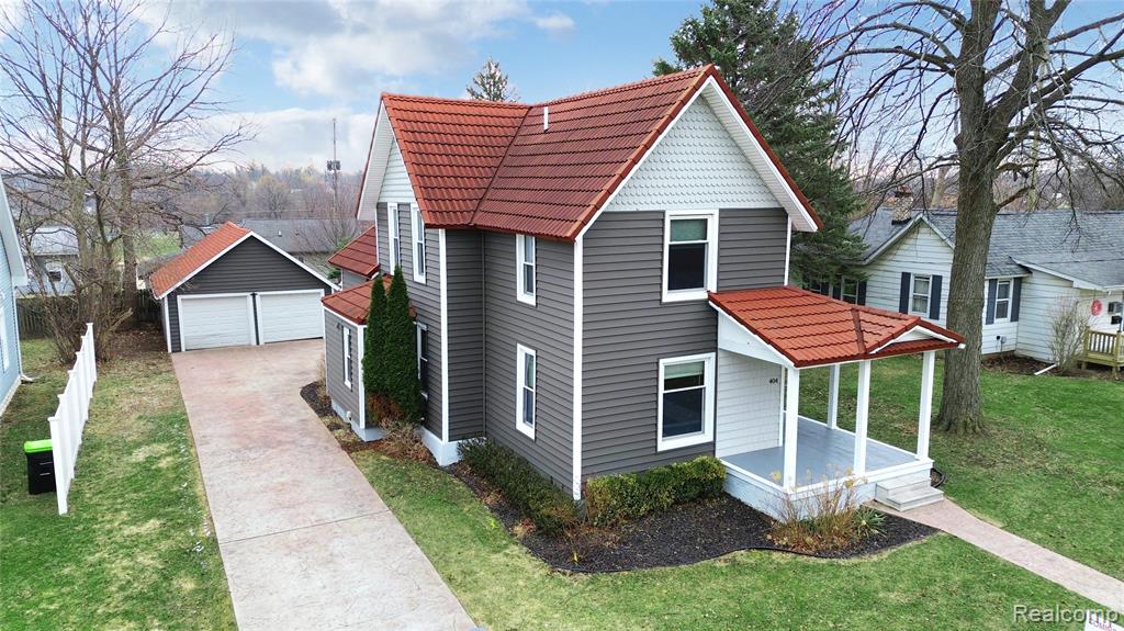 Live in the heart of the City of Fenton! This remodeled historic home was outfitted in 2018 with metal roof, all windows, stamped concrete driveway, furnace, AC, water heater, entire kitchen, stainless appliances, all 3 bathrooms, tile work, landscaping, insulation, and much more. Newer hardwood flooring throughout, and brand new carpet in 2026. This home is the perfect blend of modern and timeless with nearly every square inch of the home receiving new material in the last 8 years but the homes orignal mahogany trim, and solid wood bedroom doors remain - giving the space a one of a kind charm. This home is also equipped with first floor laundry, 3 unique full bathrooms, 4 bedrooms with main floor primary suite, and 2 car garage. Enjoy being an walking distance to downtown Fenton and located 1.5 miles from US23. Welcome to the City of Fenton!