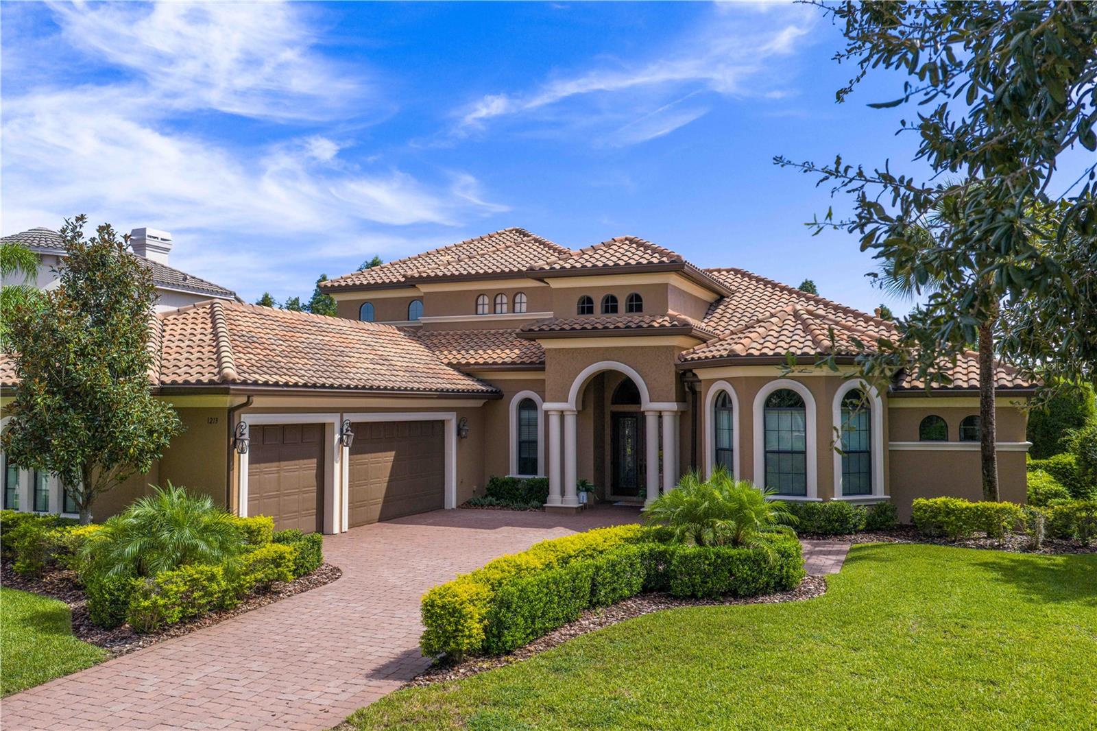 The charm of Ladera Estates - live expansively, privately, and beautifully.  Known for it’s blend of tranquility and convenience, Ladera Estates offers a unique, gated lakefront community on Lake Merrywater.    Welcome to 1213 Merry Water Drive with a timeless design, modern comfort, and breathtaking natural surroundings. Built in 2015 and situated on just under an acre with no rear neighbors, this custom-built residence offers 4882 sq ft of total living space.  Set on .98 of an acre, this estate is designed for both grand entertaining and everyday luxury. Key Features: • GREAT ROOM – Enter through double doors into the Great Room with 12-ft ceilings, surround sound, and views of the pool, conservation and pond. A comfortable family room with sliding glass doors for seamless living to the outdoor terrace. • DESIGNER KITCHEN – An oversized granite island anchors the space, complemented by a hidden walk-in pantry with a coffee bar and dining room built in storage. Open concept living with an oversized casual dining room - ideal for gatherings large or small. • PRIMARY SUITE & MAIN LEVEL ROOMS – The main-level primary suite includes dual custom walk-in closets, and spa-inspired bath with freestanding tub and oversized walk-in shower. Three additional bedrooms, as oversized study, and drop-zone with built-ins next to a large laundry room complete the thoughtful main floor. • UPSTAIRS LIVING – Two oversized suites upstairs, each with private baths and large closets—perfect for guests, teens, or multigenerational living. The upstairs entertainment zone includes a large bonus room, wet bar with fridge, and balcony overlooking the serene pond and backyard conservation views. A separate movie room with 1/2 bath complete this entertainment space • RESORT-STYLE LIVING Heated pool with sunshelf, covered and fully screened terrace, full summer kitchen, and access to a pool bath. Lush, mature landscaping and lots of extra green space are a perfect space for play or pets• ADDITIONAL HIGHLIGHTS – Features 8-foot doors on both levels, 3-car garage, custom-finished walk-in closets, pantry and additional storage closet, crown and tray ceilings throughout. • This estate is more than a home- it’s a retreat. Wake up to sunrise views, unwind in complete privacy, and enjoy the serenity of expansive natural surroundings that draw you to Ladera Estates.• Located in Lutz- one of the Tampa Bay area’s most sought-after communities for its natural beauty, larger homesites, and tranquil lifestyle- you’ll enjoy the peace of country-style living with the convenience of being just minutes from top-rated schools, hospitals, dining, shopping, major highways, and Tampa International Airport. It’s the perfect balance of space, serenity, and accessibility.