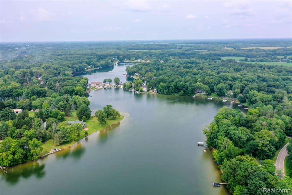 Nestled on all sports McKane Lake this single-family residence offers a unique opportunity to experience comfortable living in a desirable location. Built in 1970, this property holds the promise of becoming your weekend retreat or year round home. With three bedrooms, this residence provides ample space for rest and relaxation. Create your dream home and  imagine each bedroom as a personal sanctuary, a tranquil haven where you can unwind after a long day, recharge your spirit, and awaken refreshed, with panoramic views of the entire lake!  With a bit of updating this property presents a chance to craft a fulfilling lifestyle, where every day is an opportunity to create lasting memories.