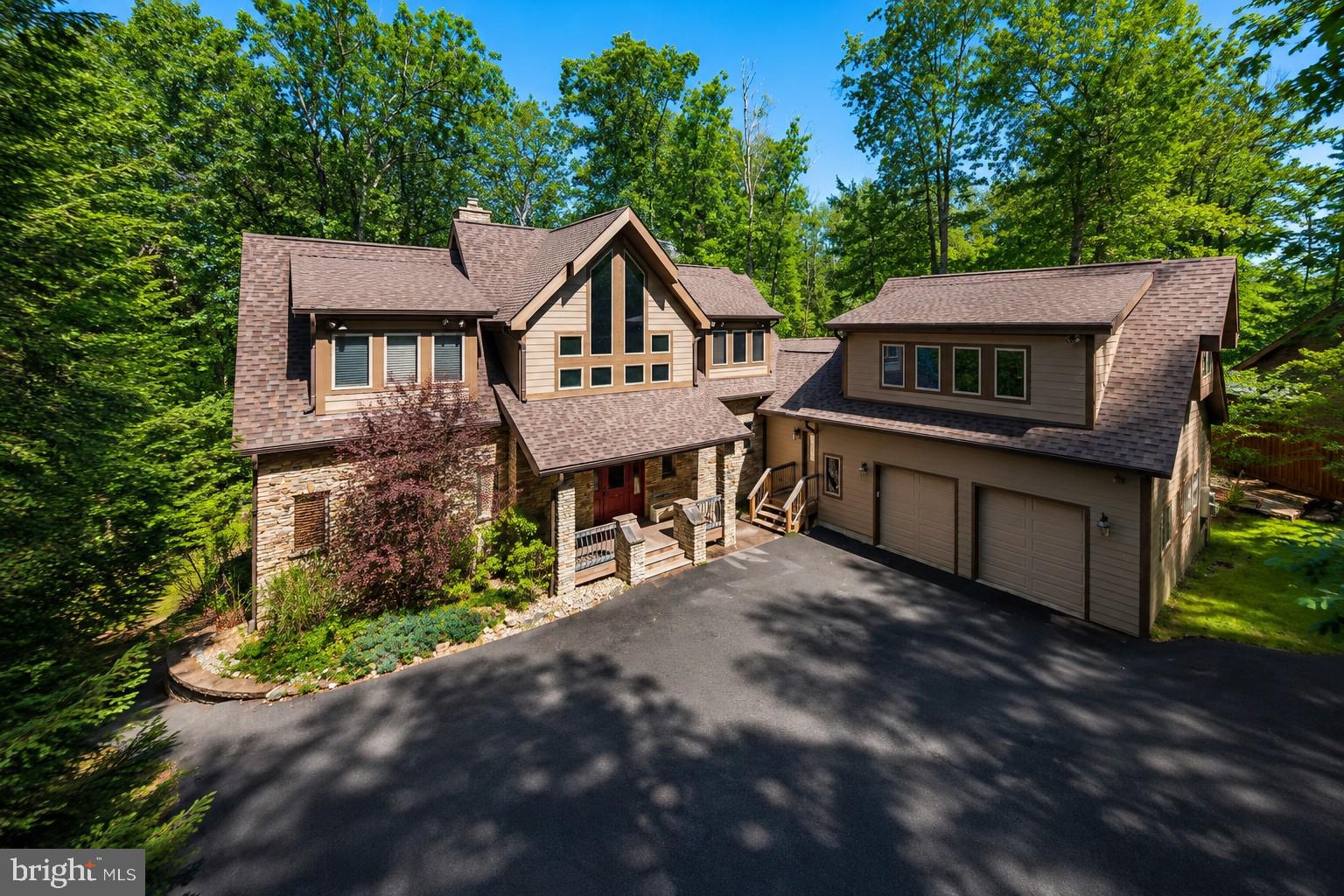 Experience unparalleled lakefront living in this meticulously maintained 6 bedroom en suite home!  Designed with an open concept plan to maximize abundant natural light and effortless transition through the kitchen, living and dining areas.  Beautiful cathedral ceilings enhance the floor to ceiling native stone fireplace.  Your living areas flow out to the expansive outdoor decking and a comfortable screened 3 season room, perfect for relaxation & entertaining.  For gathering of many guests, friends and family will enjoy all aspects of multiple living areas! Your lower level walk-out provides an additional paved patio area with oversized hot tub for year-round enjoyment! Take a stroll down the lighted path to the lakefront and revel in the beauty of the shores of Deep Creek Lake, while having fun on your private 2 slip dock.  This home also has an attached 2 car garage with bonus room above. This provides additional sleeping accommodations with sitting area and full bath.  A full list of upgrades & improvements is available for review.  Make an appointment now to take a look!