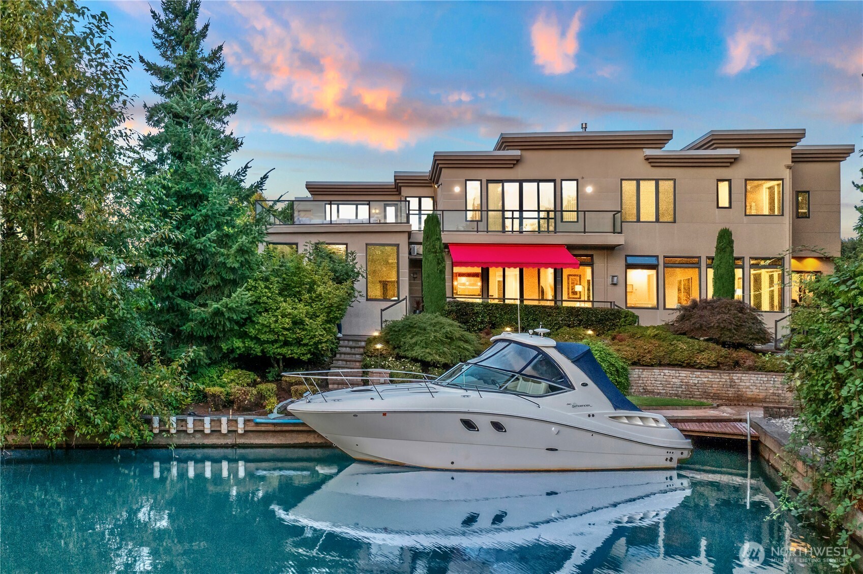 Celebrate grand scale living & entertaining in one of Newport Shores' most impressive homes in Bellevue's unique waterfront canal community. This 8,020sf luxury estate sits on a ½ acre with 117’ of protected on-lake canal moorage. A showcase entry opens to grand 10’ ceilings on each level. 5 oversized bedrooms each with a WIC & ensuite bath, including 2 Primary Suites: one on the main floor & a true Primary Retreat with sitting area, FP, deck & enormous WIC. 8 Bath Rooms,TRUE gourmet kitchen has Wolf & SubZero appls, Media room, Office, bonus rooms, 2 laundry rooms, INDOOR POOL+SPA & large roof top deck. Radiant floors & AC. Enjoy your Newport Yacht Club membership with many amenities. *HOME COMES W/ the BONUS 33’ SEA RAY YACHT*(negotiable)