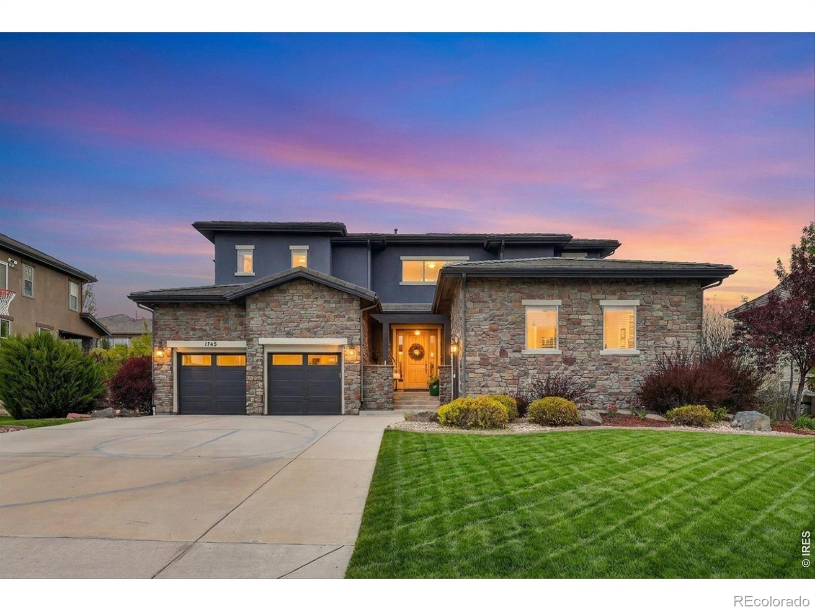Stunning home in the highly sought-after The Preserve at McKay Shores community, offering a rare blend of thoughtful design, effortless functionality, and elevated Colorado living. This exceptional five-bedroom, four-bath residence showcases a highly desirable floor plan, anchored by a main level primary suite that delivers both everyday ease and long-term flexibility, ideal for multi-generational living or refined main floor living without compromise.Step inside to a light-filled interior where soaring ceilings and a dramatic two-story family room create an immediate sense of volume and openness. The living, dining, and kitchen spaces flow seamlessly, designed for both elevated entertaining and comfortable daily life. At the center, the kitchen impresses with a generous island, rich espresso cabinetry, granite countertops, stainless steel appliances, and an oversized pantry, all perfectly positioned to connect with the dining area and gathering spaces.Thoughtful details continue throughout, including a spacious laundry room, powder bath, and a well-designed drop zone just off the garage. The primary suite offers a quiet retreat, complete with a well-appointed en suite bath and walk-in closet. A two-car garage plus a separate third-car garage provides exceptional flexibility and storage.Upstairs, four additional bedrooms are thoughtfully arranged in a wing-style layout, featuring a Jack and Jill bath and a separate full bath, all connected by an open walkway that overlooks the family room below.The unfinished basement presents a rare opportunity for future expansion, with rough-in plumbing and generous ceiling height. Outdoors, a beautifully maintained yard, extended patio, and pergola create a private setting for relaxed evenings or effortless entertaining.Ideally located near parks, trails, and open space, this home captures the essence of Colorado living with both style and intention.