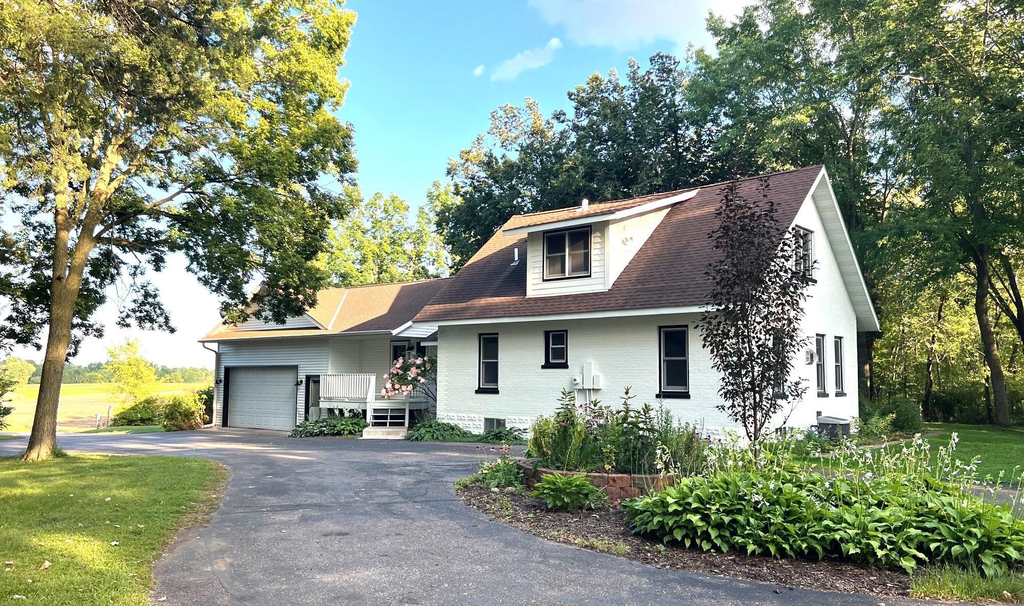 Nestled in the new upscale development of the SHORES OF LAKE JOHN, this modern farmhouse sits on 1.53 acres with 86' of sandy lakeshore and sunsets on Lake John! This lovely 2140 sq. ft home has 3 BRs, 3 Baths, an oversized attached 2-car garage, expansive Bonus Room Loft, beautiful hardwood and tile floors, spacious kitchen with custom cabinets, stainless steel appliances, several built-ins, a corner gas fireplace, ceiling arch, large Mudroom/Pantry, bright sunroom and 3-season screened porch. The unfinished basement offers ample storage and 750 sq. ft. of future living space. The outdoor patio, inviting front porch, long circle drive, wooded landscape and gorgeous lake views make this property feel like home!  Additionally, the picture-perfect 3-story Guesthouse has history and character with its sliding peek-a-boo barn door window, attractive awning, ribbed metal roof, and rich knotty pine interior. Ideal for a bunkhouse, home office or workout space/home gym. Its insulated Lower Level offers more storage or make it your Workshop. The possibilities are endless! Enjoy the new neighborhood trail and lakeside green space, year-round community and lake activities, nearby Southbrook golf course and downtown Annandale shops and restaurants - only 45 minutes from the Twin Cities!  The lot shown is in the process of final city approval.