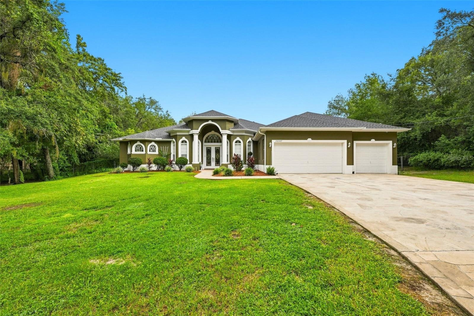 Welcome to your private Florida retreat! Situated on a tranquil, 1.3-acre agricultural lot at the end of a quiet dead-end street, this modern 3-bedroom, 3-bathroom sanctuary offers the perfect blend of rural freedom, with no HOA or CDD fees, and ultimate convenience. Surrounded by mature shade trees and sitting high at 80 feet above sea level (no flood insurance required!), this estate features nearly 3,000 sq. ft. of air-conditioned living space and over 5,000 sq. ft. total under cover, including the garage, screen-enclosed pool with expansive lanai, and a dedicated custom catio.Designed for low-cost, energy-efficient, and worry-free living, the home comes equipped with 40 solar panels (slashing electric bills to near zero), a whole-home generator with a 250-gallon propane tank, a roof under 2 years old, fresh exterior paint, dual-zone HVAC systems, and a full-property irrigation system fed by abundant local spring water. Security is complete with an ADT system, while outdoor enthusiasts will love the fully fenced backyard for pets, an area already cleared for a chicken coop, and the beginnings of a cozy backyard fire pit amidst nature visits from local owls, hawks, and hummingbirds.Under 10 minutes to daily shopping; 1.4 miles to Tampa General Hospital Spring Hill and 3.1 miles to Planet Fitness. Endless top-tier local restaurants within a 15-minute drive.15 minutes to historic Brooksville, 30 minutes to Tampa International Airport (TPA) & downtown Tampa, and under 45 minutes to virtually everything the Suncoast has to offer.