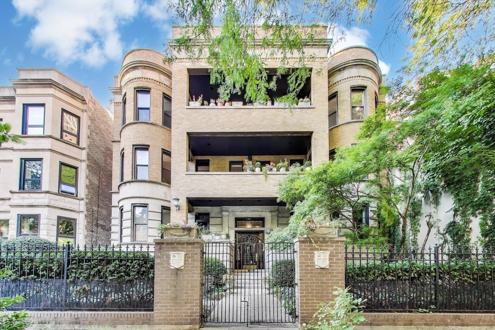 **MULTIPLE OFFERS-DEADLINE FOR HIGHEST AND BEST OFFERS FOR TOMORROW, TUESDAY 9/9 AT 9AM**Just steps from the Lake, this stately 3-bedroom, 2-bath residence offers the space, privacy, and comfort of a single-family home. Nestled on a picturesque East Lakeview block in a boutique six-unit 1920's brick building and surrounded by landscaped gardens, this home combines classic elegance with modern updates. This architectural gem exudes vintage charm the moment you approach the center entrance. The handsome turrets not only contribute to its commanding curb appeal, but also hint at the historic elegance found within. The expansive living room is filled with natural light from its 9 ft ceilings and an elegant curve formed by the turret allows for both southern and western exposures. Direct access to a front terrace tucked among the trees is perfect for relaxing or entertaining, or cozy up to the wood burning fireplace. A formal dining room with a striking coffered ceiling leads to the thoughtfully designed chef's kitchen with timeless white cabinetry, Silestone quartz counters, and stainless eat-in bar. Premium appliances include a KitchenAid dual oven with convection, 5-burner Fisher & Paykel cooktop (vented to the outside), LG French door refrigerator, and Bosch panel-front dishwasher. Efficient storage solutions make this kitchen as practical as it is beautiful. The primary suite is a true retreat, offering an impressive walk-in closet and a luxurious spa-like marble bath with a walk-in rain shower, soaking tub, and Restoration Hardware chrome fixtures and mirrors. Both bathrooms are finished with high-end vanities, Toto and Kohler toilets, and stylish polished chrome details. Hardwood floors and 9-foot ceilings run throughout. Enjoy central Heat and AC, front loading Washer/Dryer, a versatile bonus room, and additional dedicated large storage space & bike parking in the basement. Parking and EV rental options available nearby. Pet-friendly, all owner-occupied (no rentals) and self-managed building by dedicated homeowners with low $368 monthly assessments. A perfect place to call home!