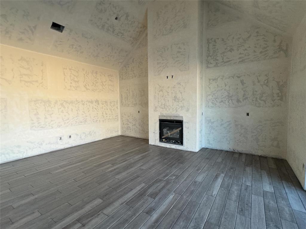 This Wesley Bonus Room floor plan includes 3,630 Sqft of total living space, which features 3,285 Sqft of indoor living space and 345 Sqft of outdoor living space. There is also a 590 Sqft, three-car garage with an in-ground storm shelter installed! This desirable home offers 5 bedrooms, 3 full bathrooms, covered patios, a large bonus room, a powder room, and a utility room featuring a utility sink. The great room supports an immaculate cathedral ceiling with a crows feet detail and a ceiling fan, a luxurious 3-panel sliding door with a 4’ back patio extension, wood-look tile, rocker switches throughout, Cat6 wiring, eggshell paint, and a gas fireplace featuring a stacked stone detail and built-in lower cabinets on both sides. The upscale kitchen boasts stunning pendant lighting, stainless steel appliances including double ovens and a 5-burner cooktop, 3 CM countertops, vogue tile backsplash, well-crafted cabinets to the ceiling with cabinet hardware throughout and under cabinet lighting, decorative end panels, a separate walk-in pantry, and a large center island that holds a roomy sink, a dishwasher, and a trash can pullout. The primary suite provides a sloped ceiling detail, a ceiling fan, a plush carpet finish, and windows. Attached is the main bath, which has a bat-winged vanity with framed mirrors, 3 CM countertops, a large European walk-in shower, a private water closet with an elongated toilet, a free-standing tub, and a HUGE walk-in closet! The covered outdoor living area welcomes a wood-burning fireplace, a gas line for your grill, and a handy TV hookup. Other included features for this elegant home include our healthy home technology, an air filtration system, a tankless water heater, double glazed vinyl low E windows with argon, R-44 and R-15 insulation, a fresh air ventilation system, and so much more!