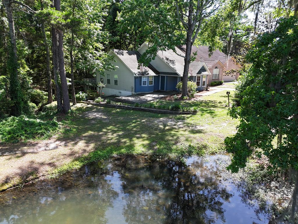 Tucked away at the end of a quiet cul-de-sac, this well-maintained 1,392 sq ft cottage offers a peaceful retreat with all the comforts of home. Recently painted and move-in ready, it features a spacious master bedroom with plantation shutters and a private deck to enjoy the serene lake views. The master bath includes a jetted tub and space for a washer and dryer.  The second bedroom and bath are conveniently located down the hall, offering privacy and comfort. The inviting living room centers around a gas log fireplace (just needs propane hookup) — perfect for cozy evenings. The open kitchen comes fully equipped with appliances, and the adjoining dining room comfortably seats eight with a matching china cabinet for added elegance.  Step outside to take in the tranquil setting, with walking paths and breathtaking lake views right outside your door. This home combines privacy, charm, and natural beauty — don't miss the opportunity to make it yours!
